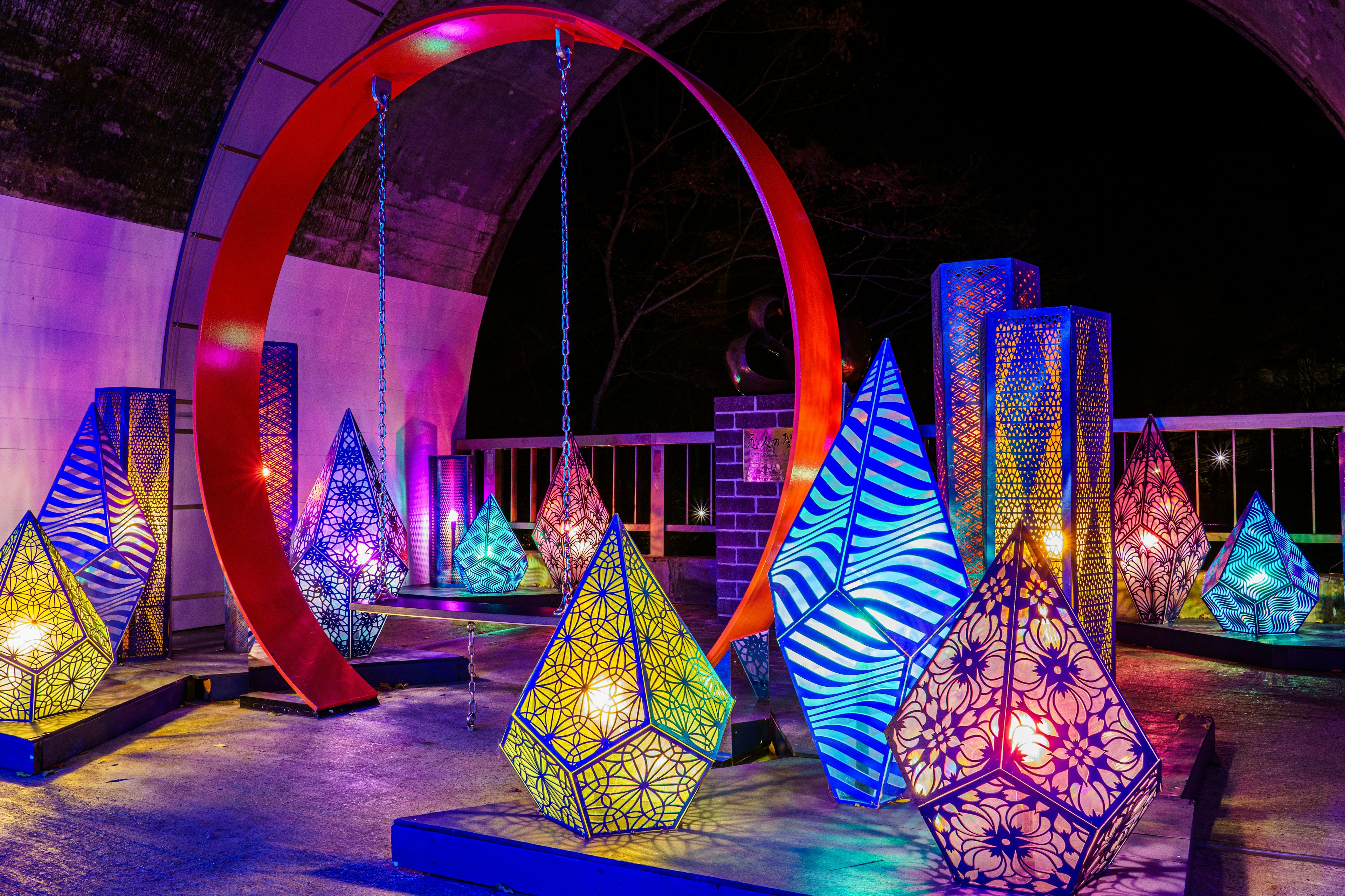 Colorful lamps and decorative objects arranged in an outdoor art installation