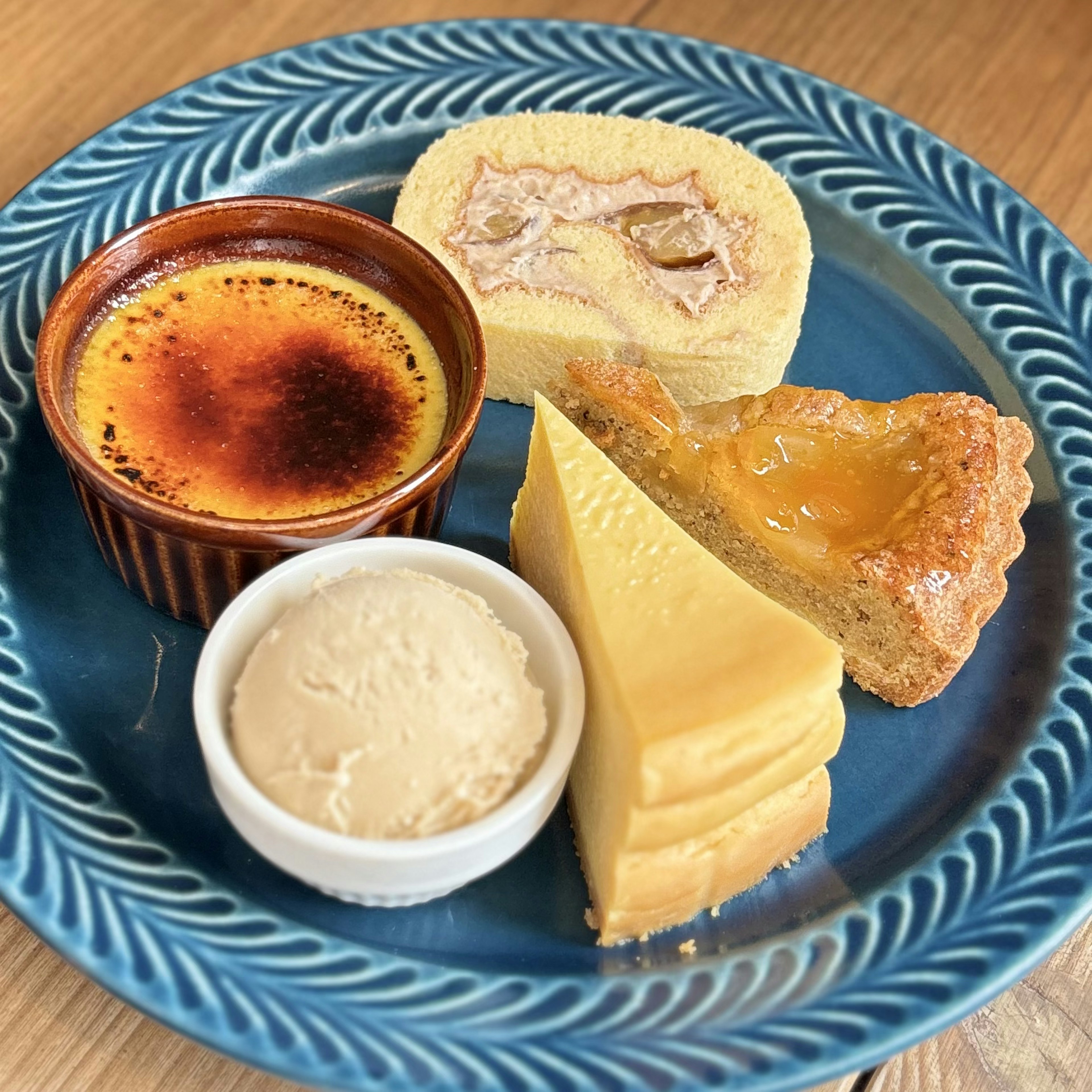 A dessert platter featuring crème brûlée fruit roll cake custard pudding and butter tart