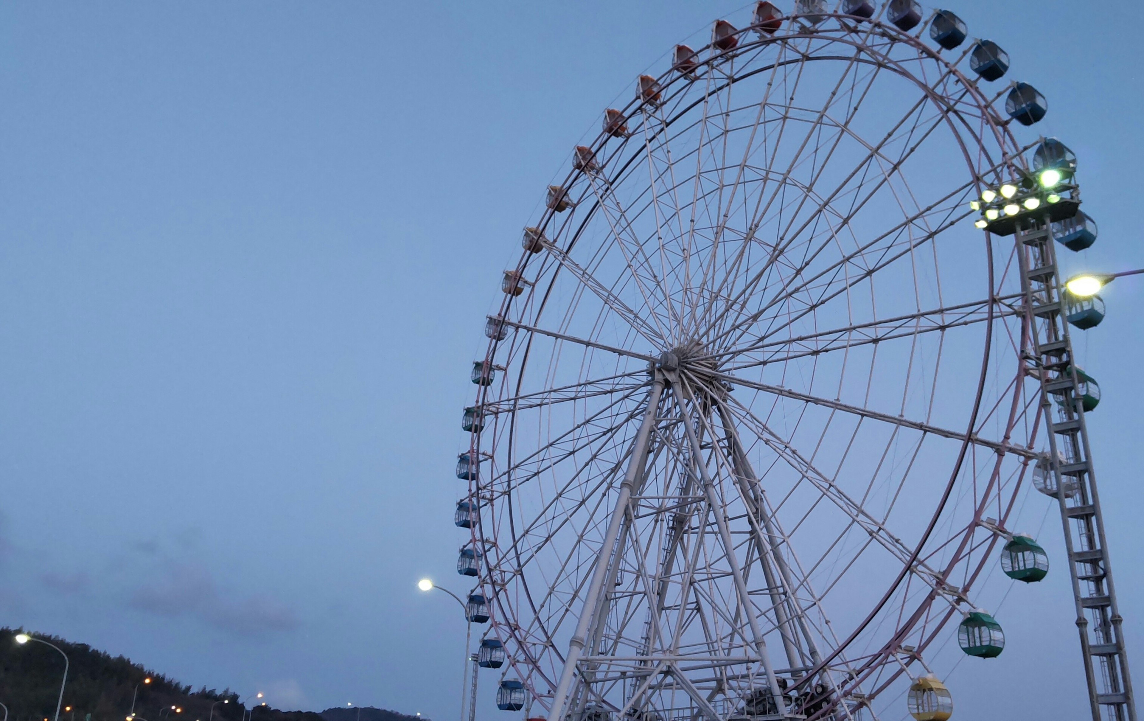 Ein Riesenrad, das unter dem blauen Himmel bei Nacht ragt