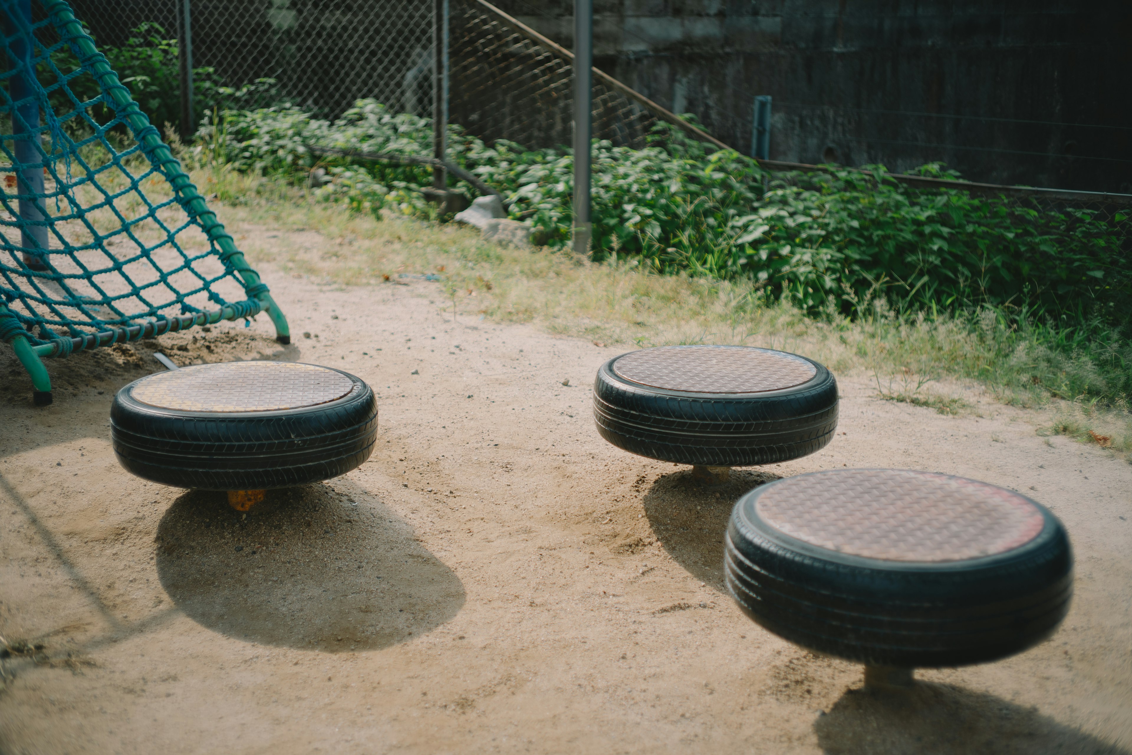 Three tire balance balls on a playground surface