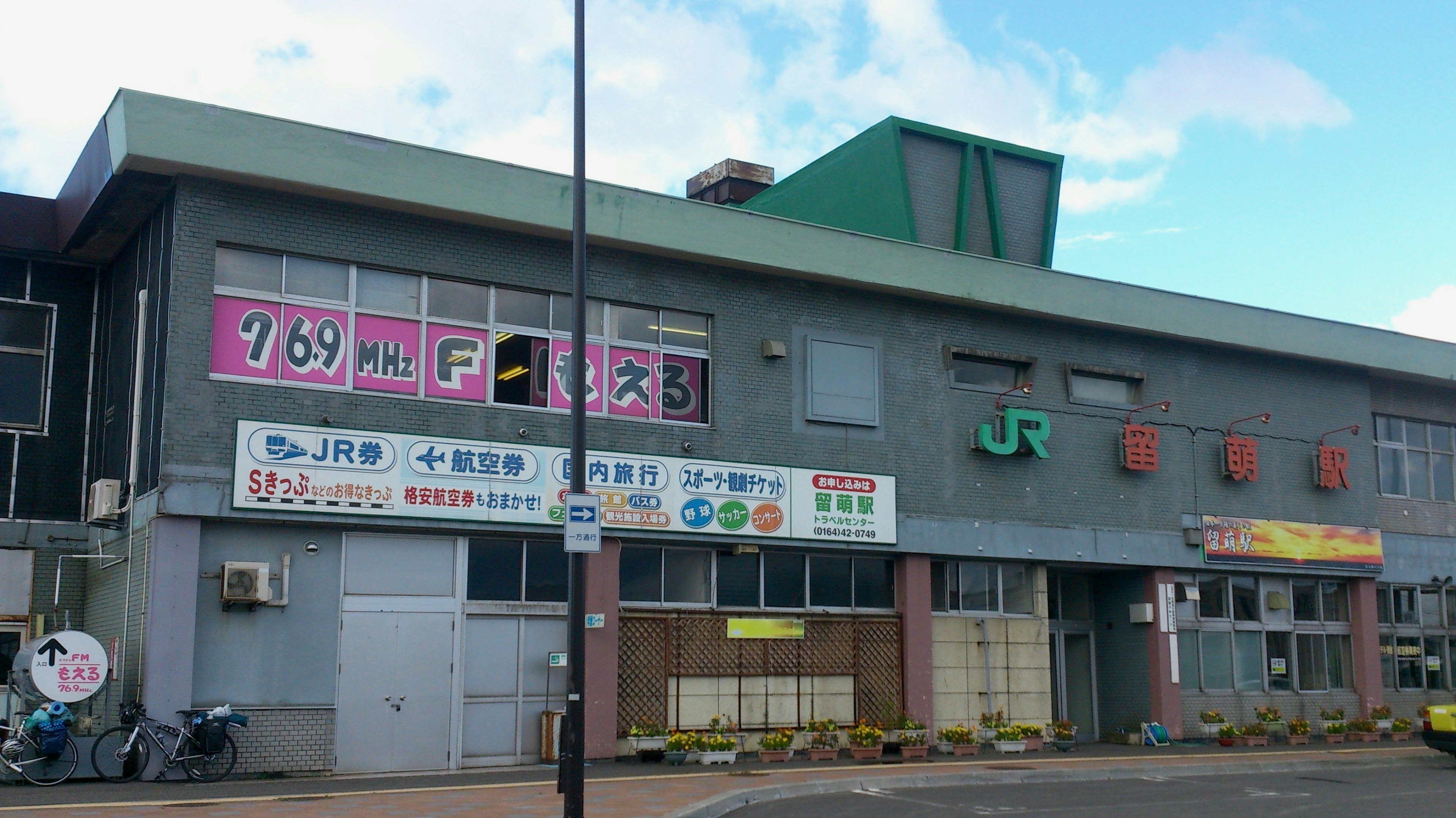 Vista exterior de una estación JR con señalización brillante