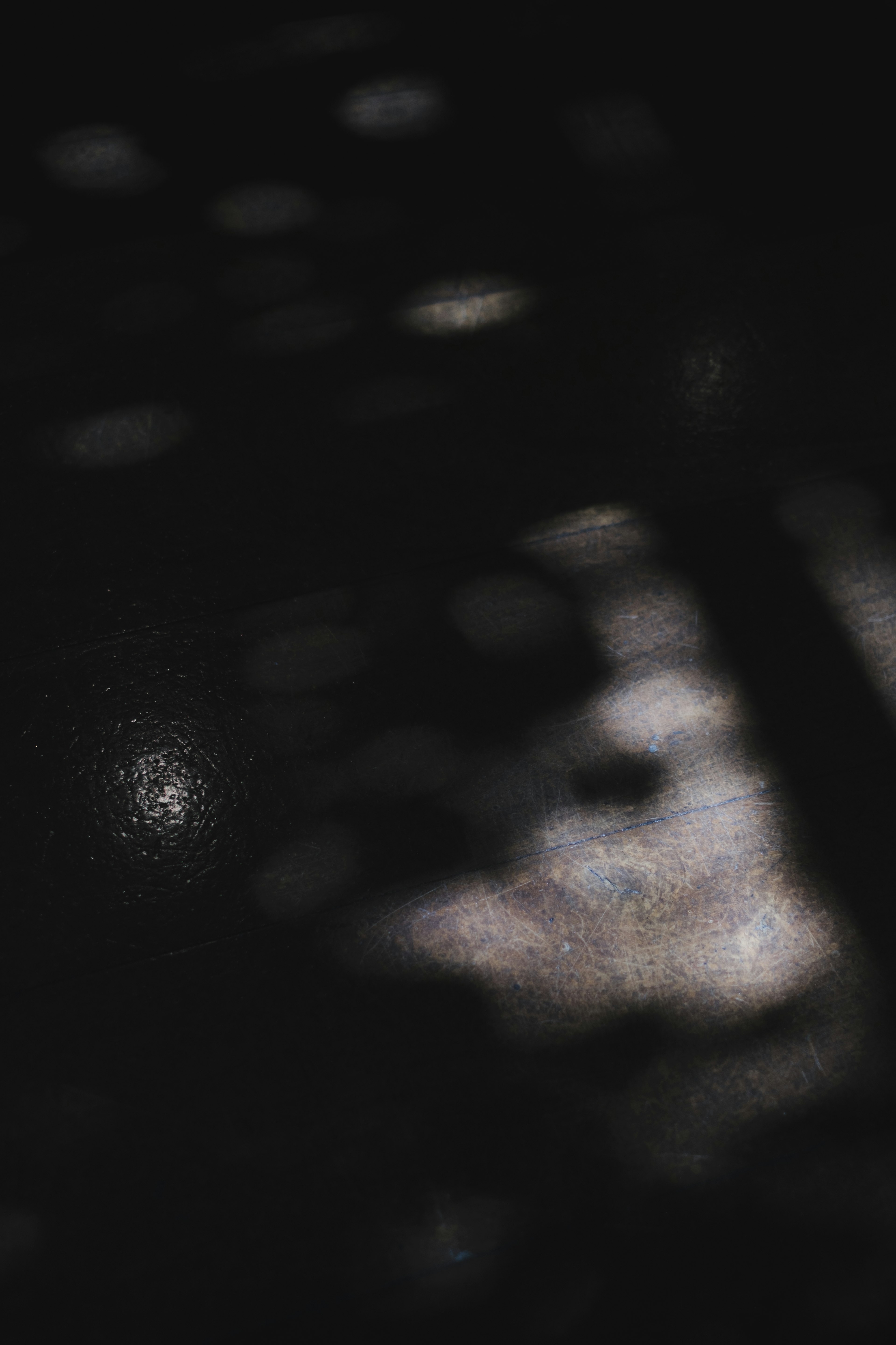 Abstract image with light spots emerging against a dark background