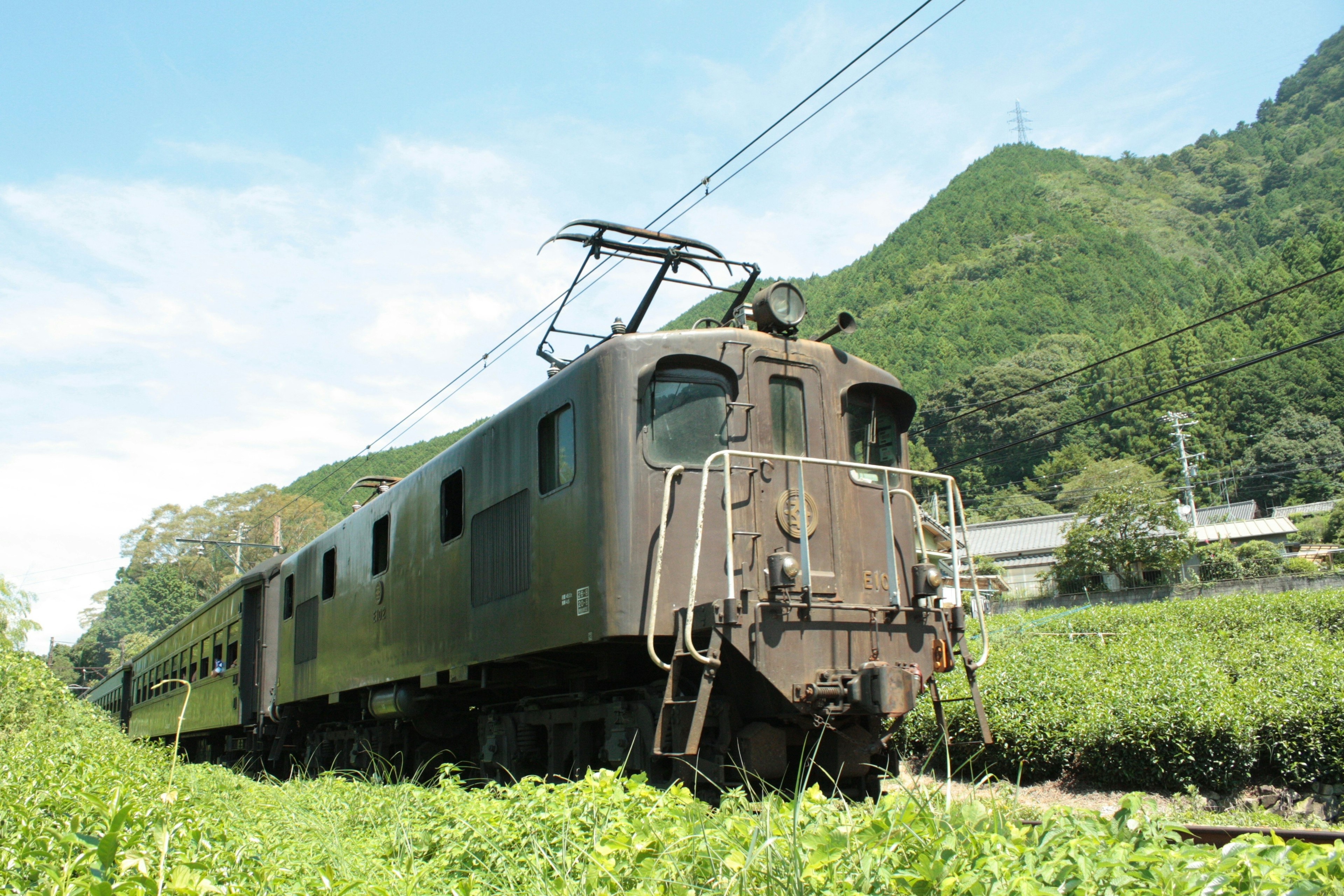 Vecchia locomotiva di treno ferma in un campo verde