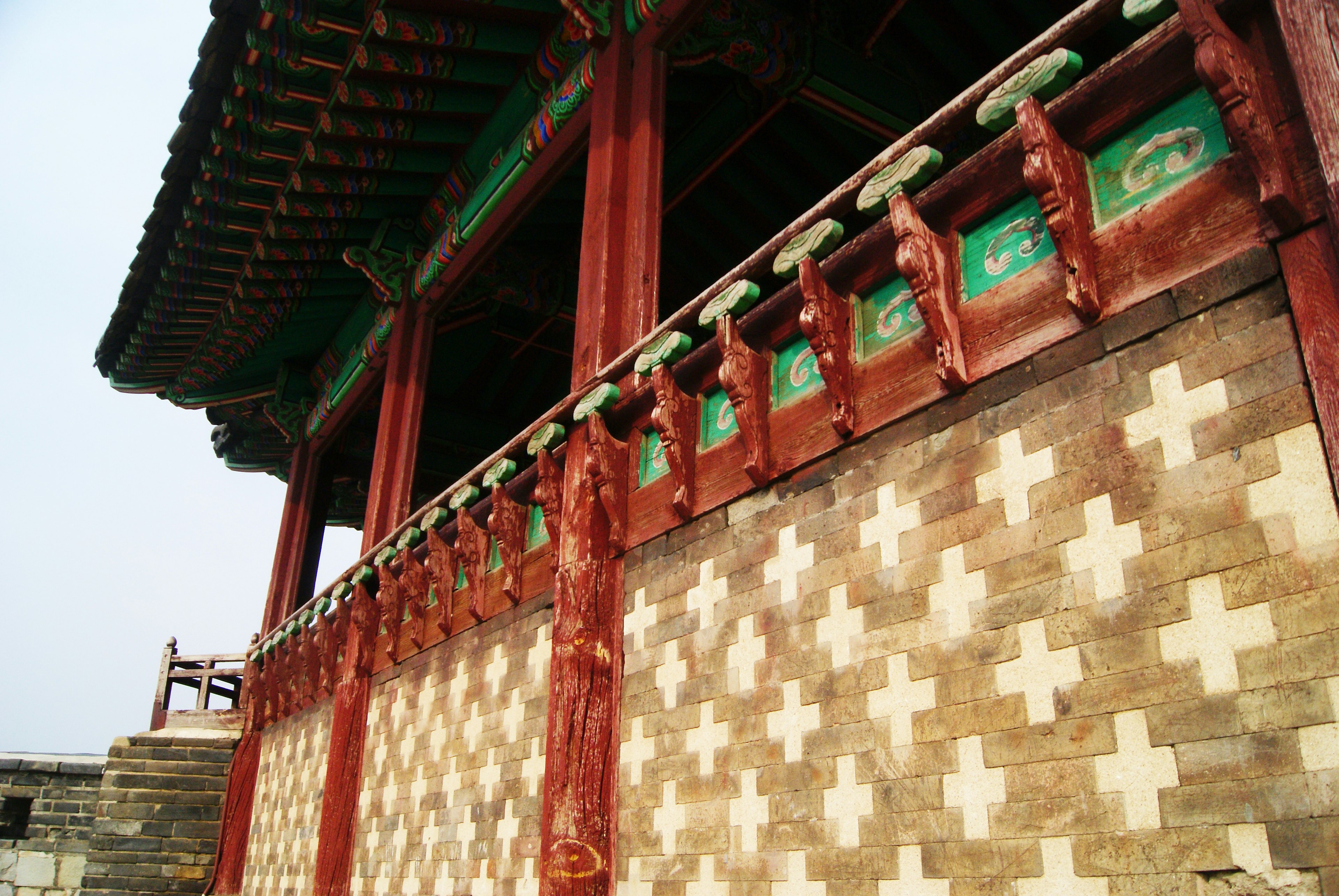 Detailed view of traditional architecture featuring colorful roof and patterned wall