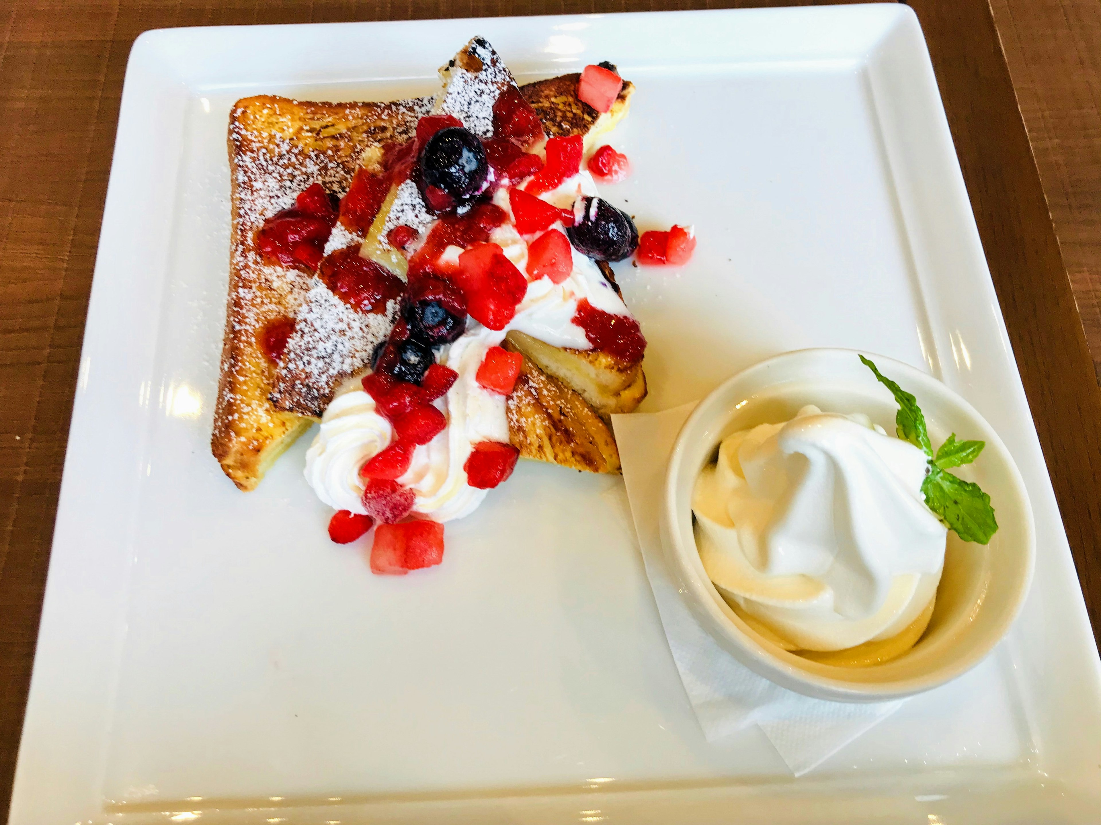 French toast topped with mixed berries and whipped cream