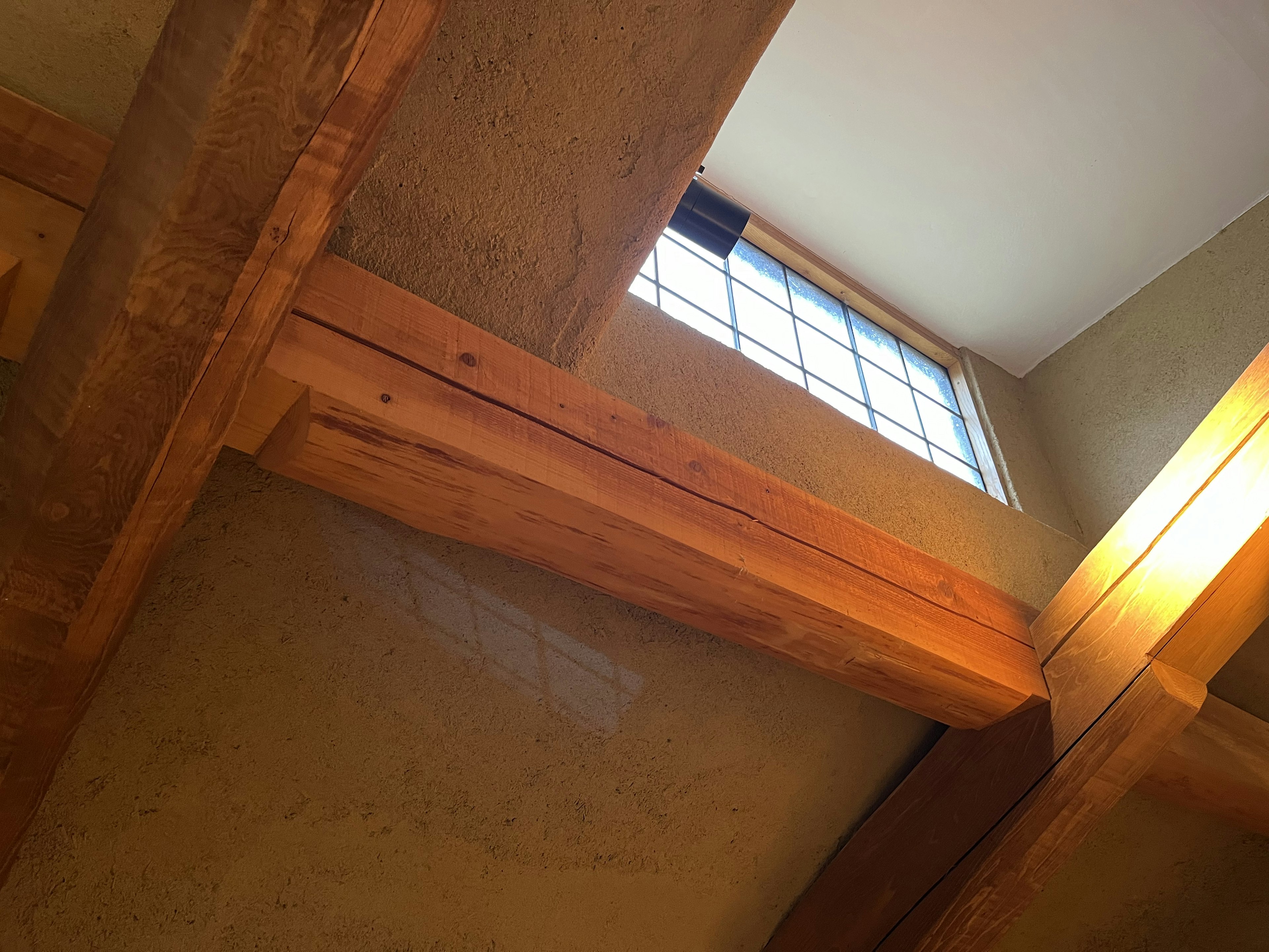 Interior view featuring wooden beams and a window