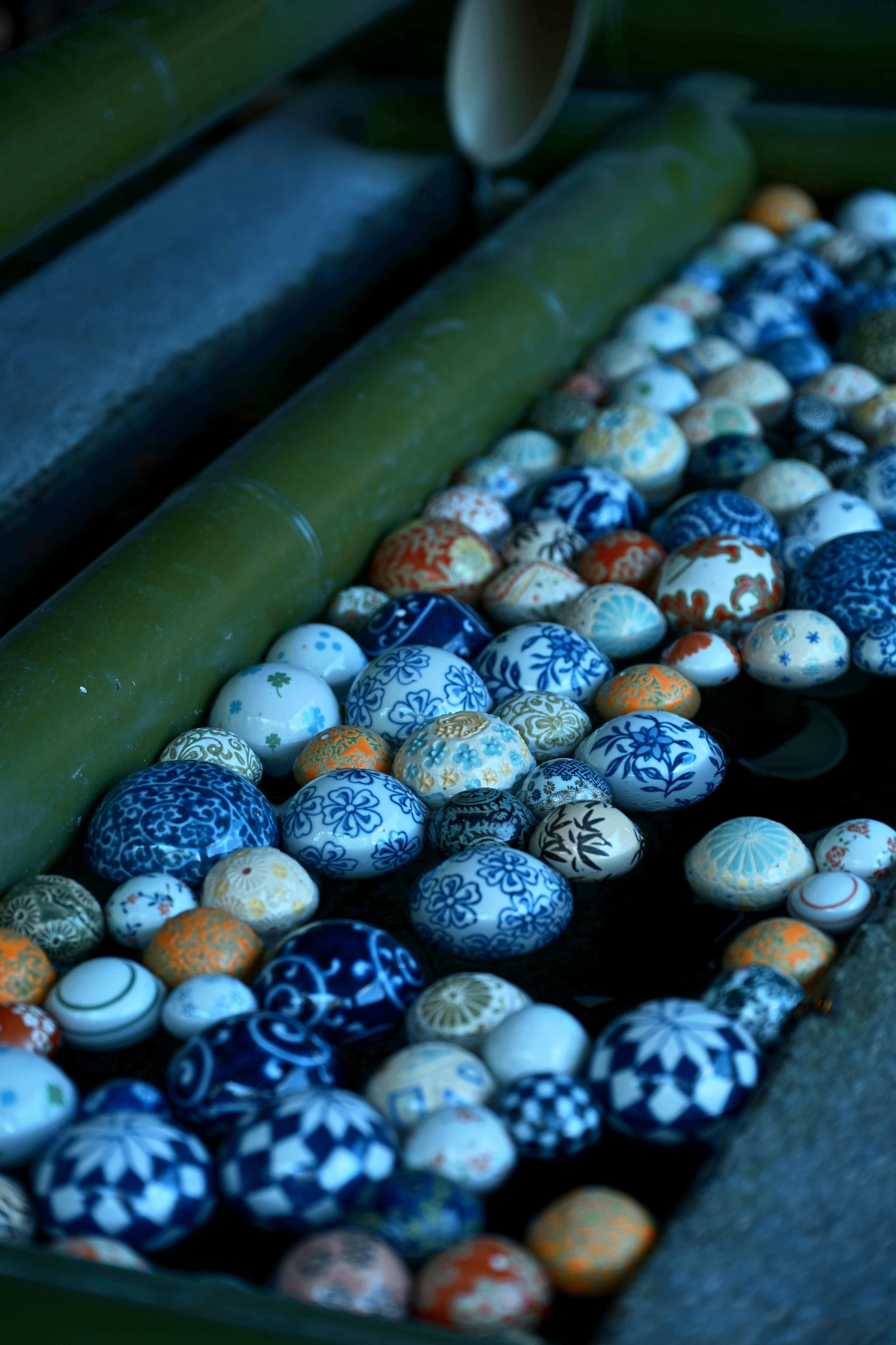 Various patterned ceramic balls arranged against a blue background