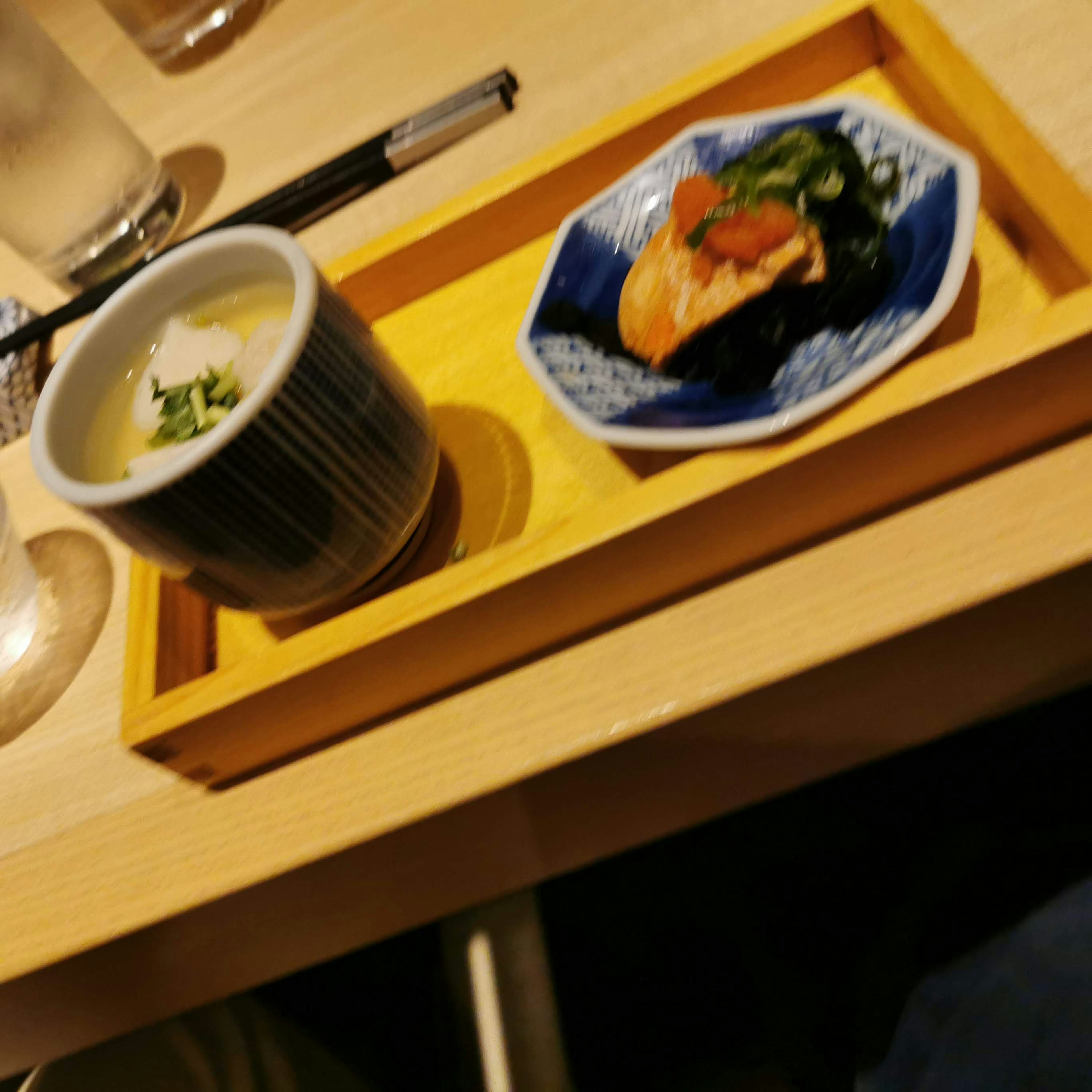 Japanese small dish with steamed egg and vegetables served on a wooden tray