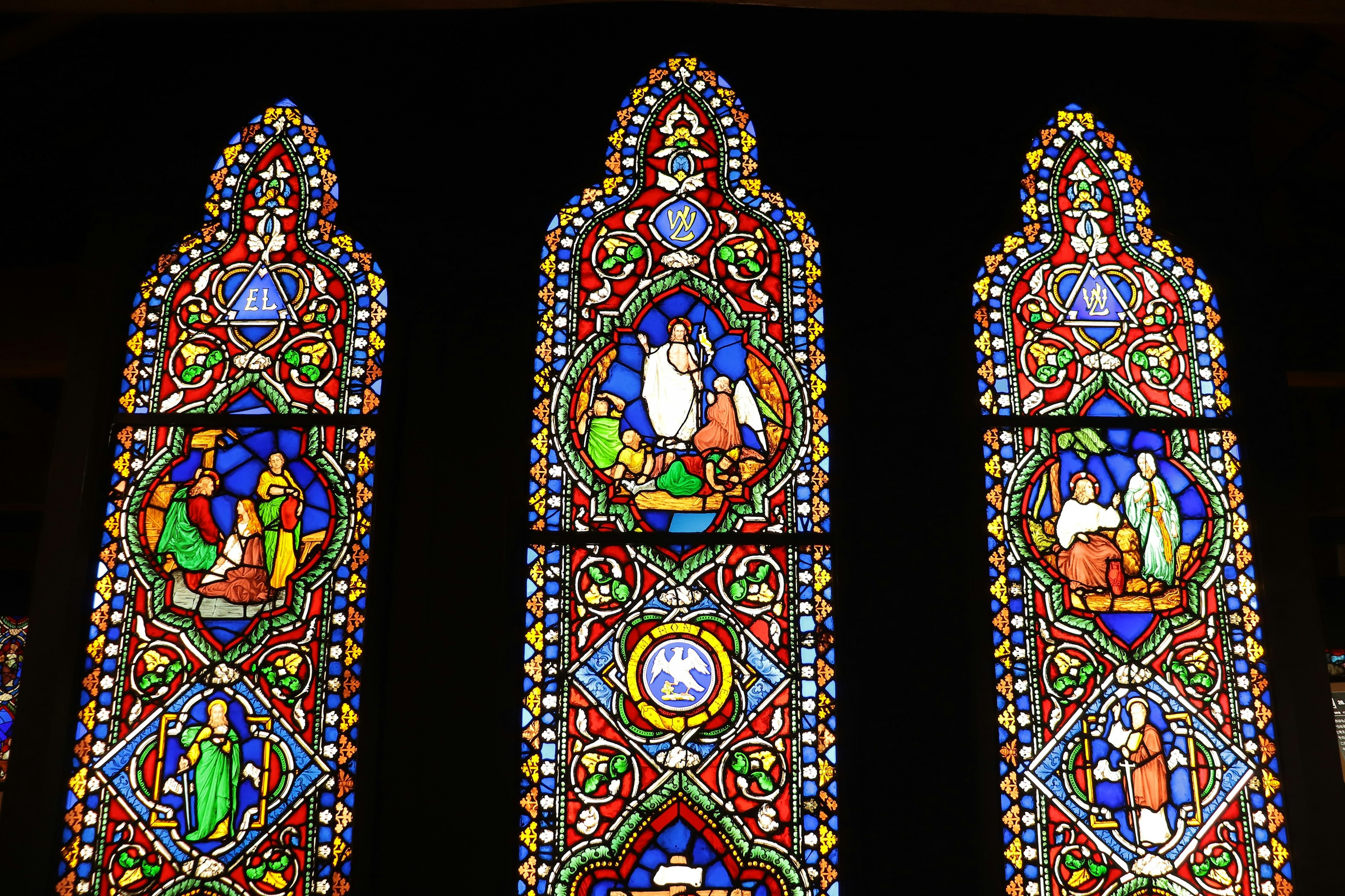 Colorful stained glass window depicting religious scenes