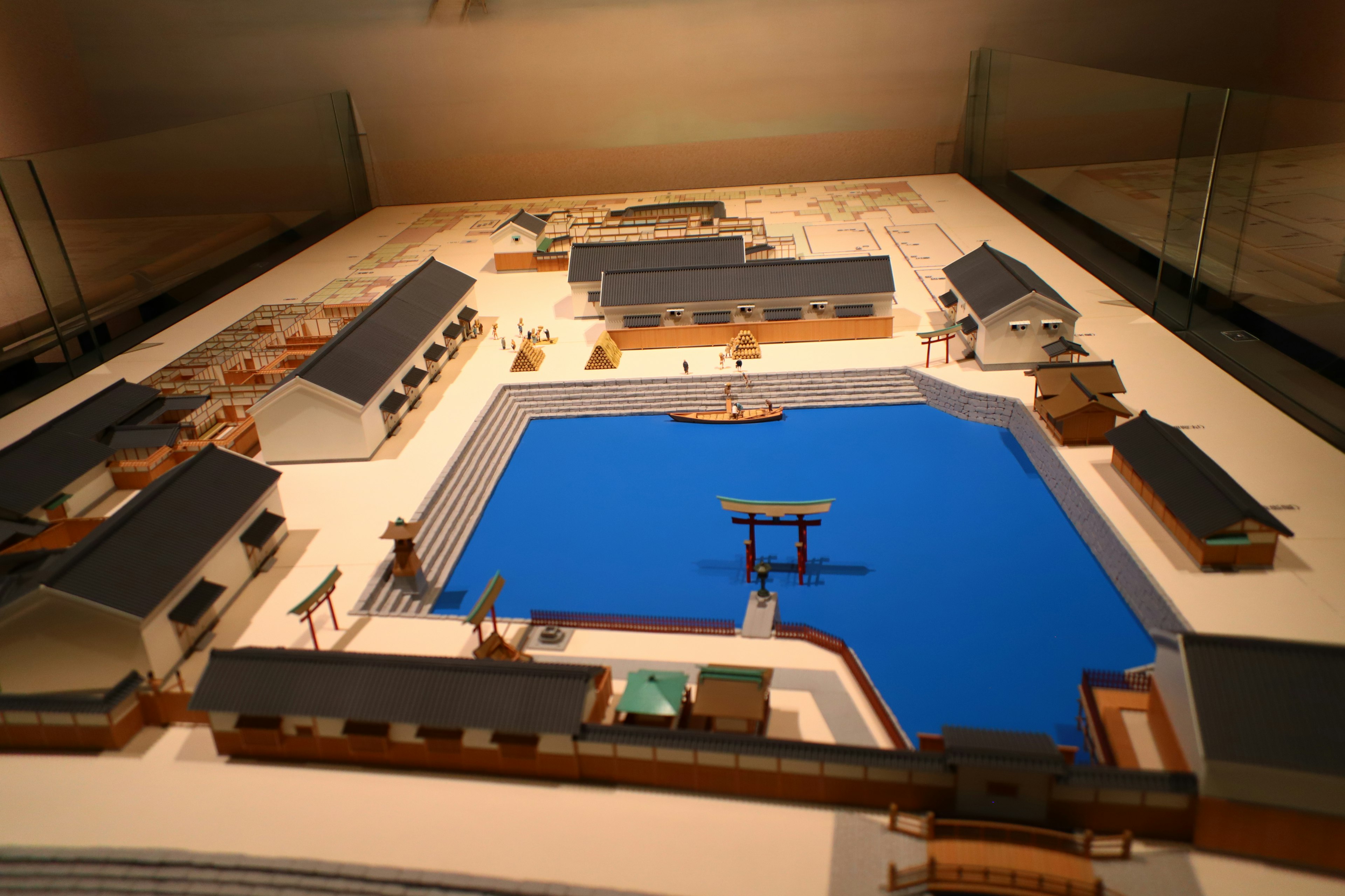 Diorama featuring a town layout with a blue pond