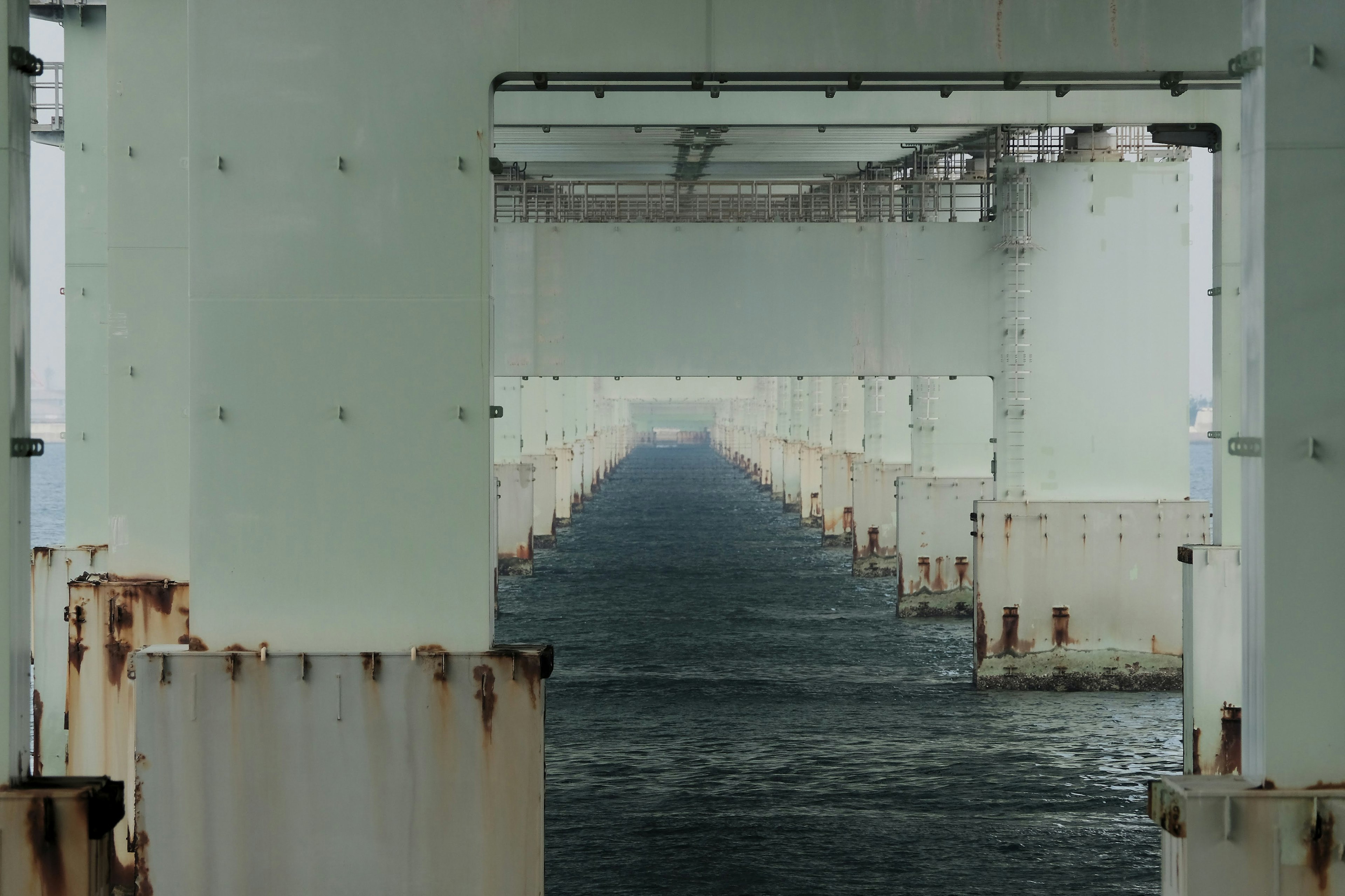 Interior view of a bridge with columns above water