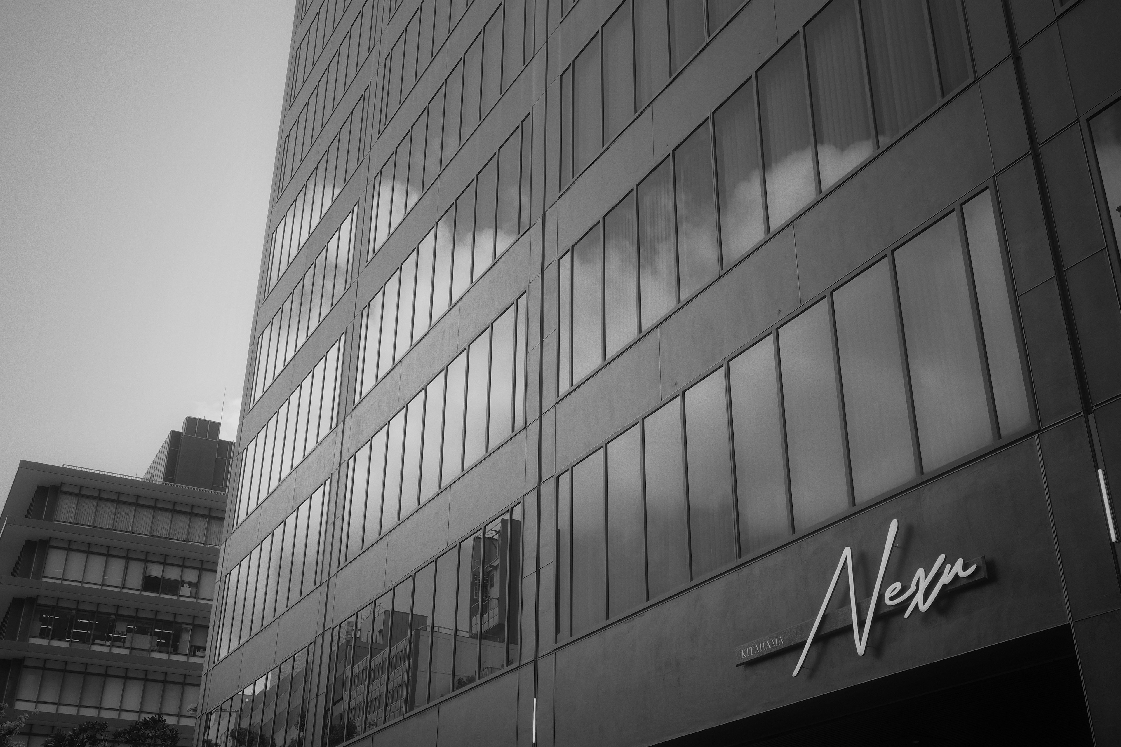 Modern building facade with reflected clouds