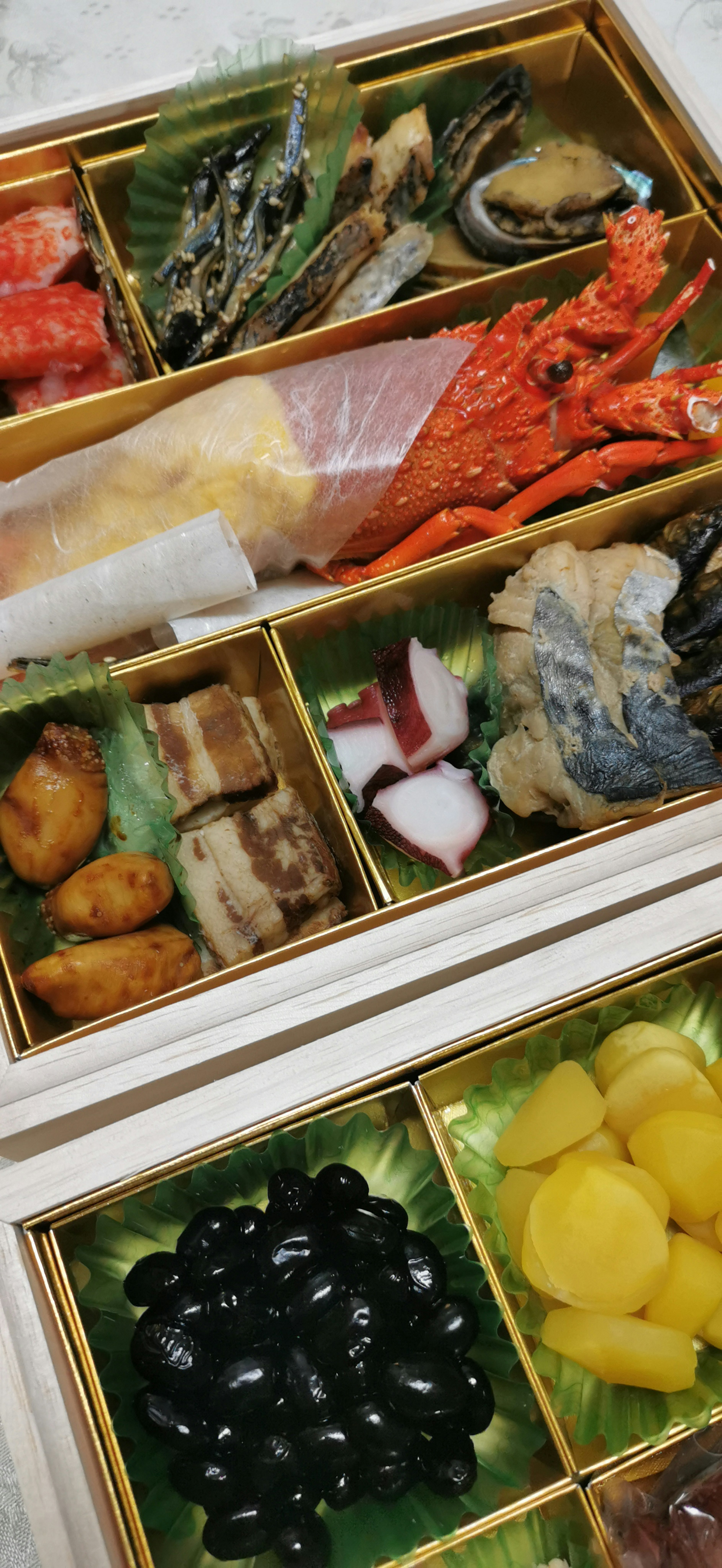 A colorful assortment of Japanese cuisine presented in a traditional jubako