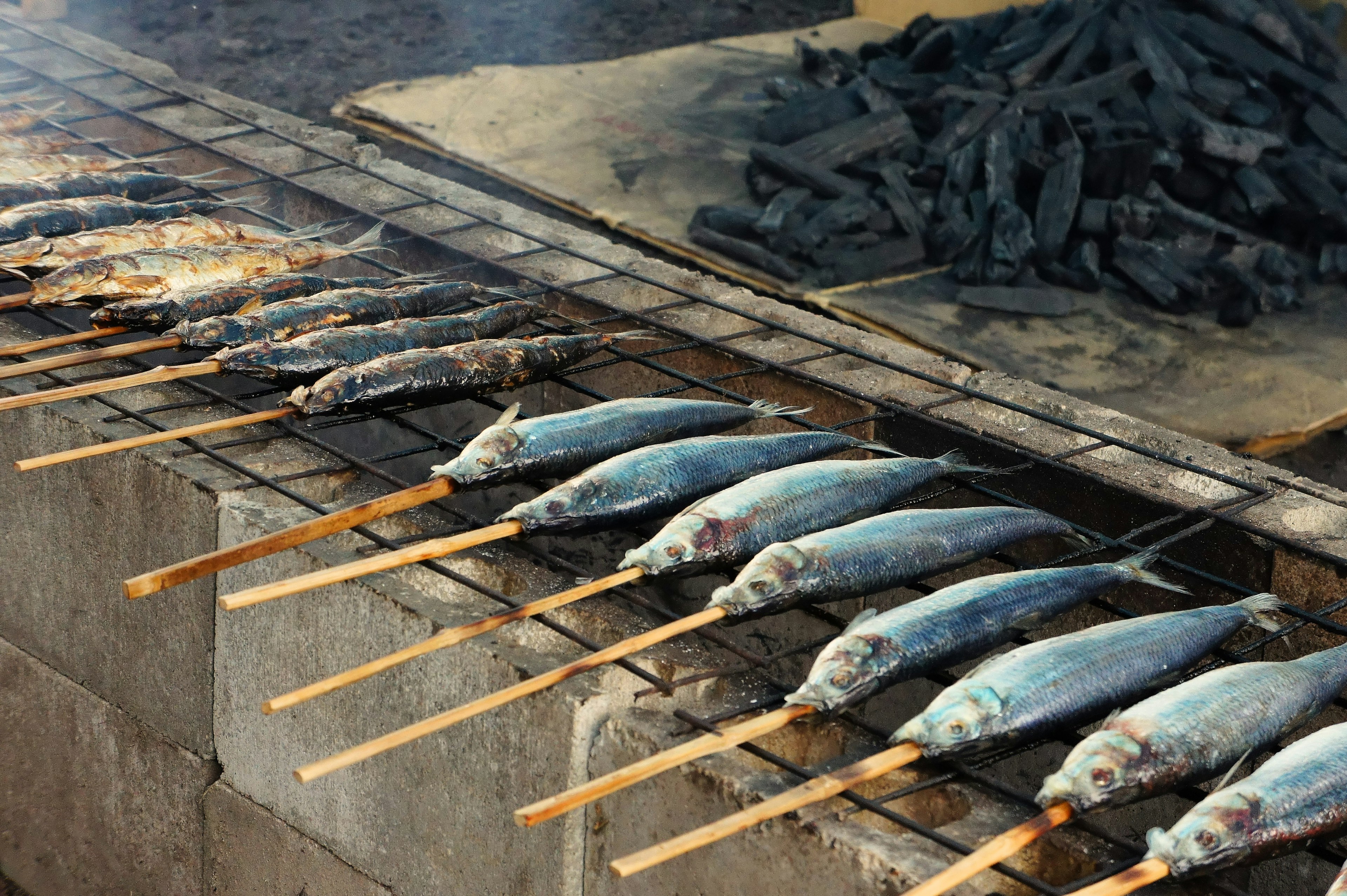 Grilled fish skewers arranged on a grill