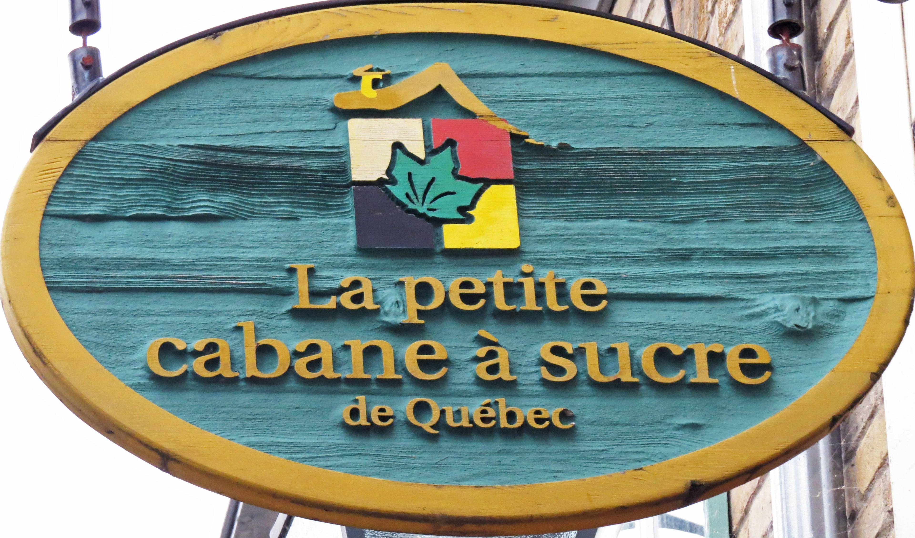 Sign for La Petite Cabane à Sucre in Quebec featuring colorful design