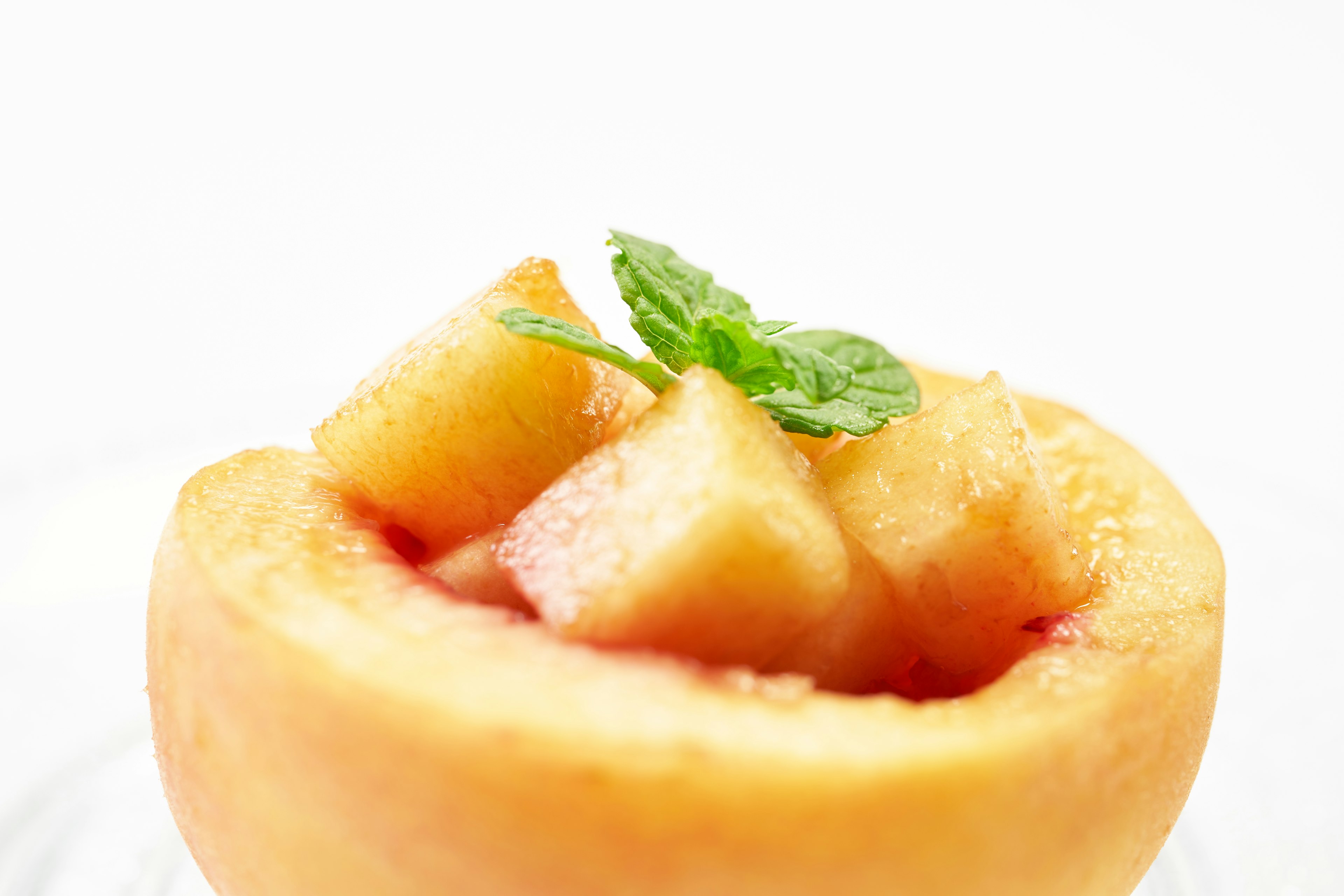 Sliced melon with mint leaves inside a hollowed-out melon