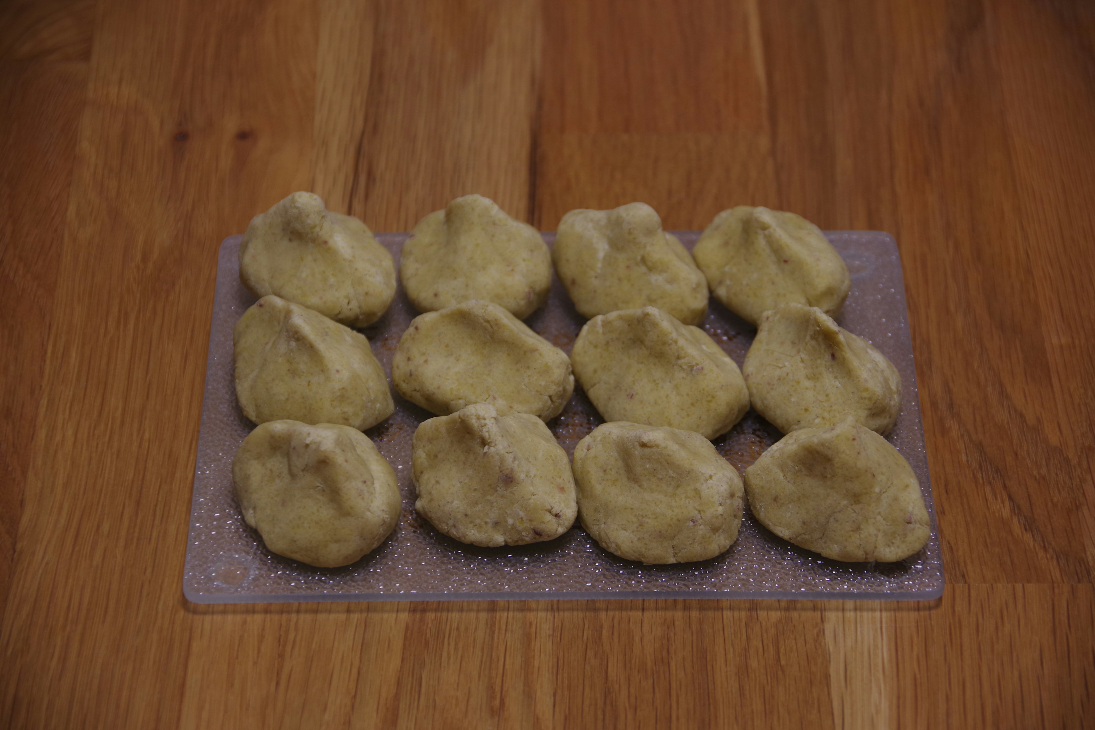 Pequeñas bolas de masa dispuestas sobre una mesa de madera