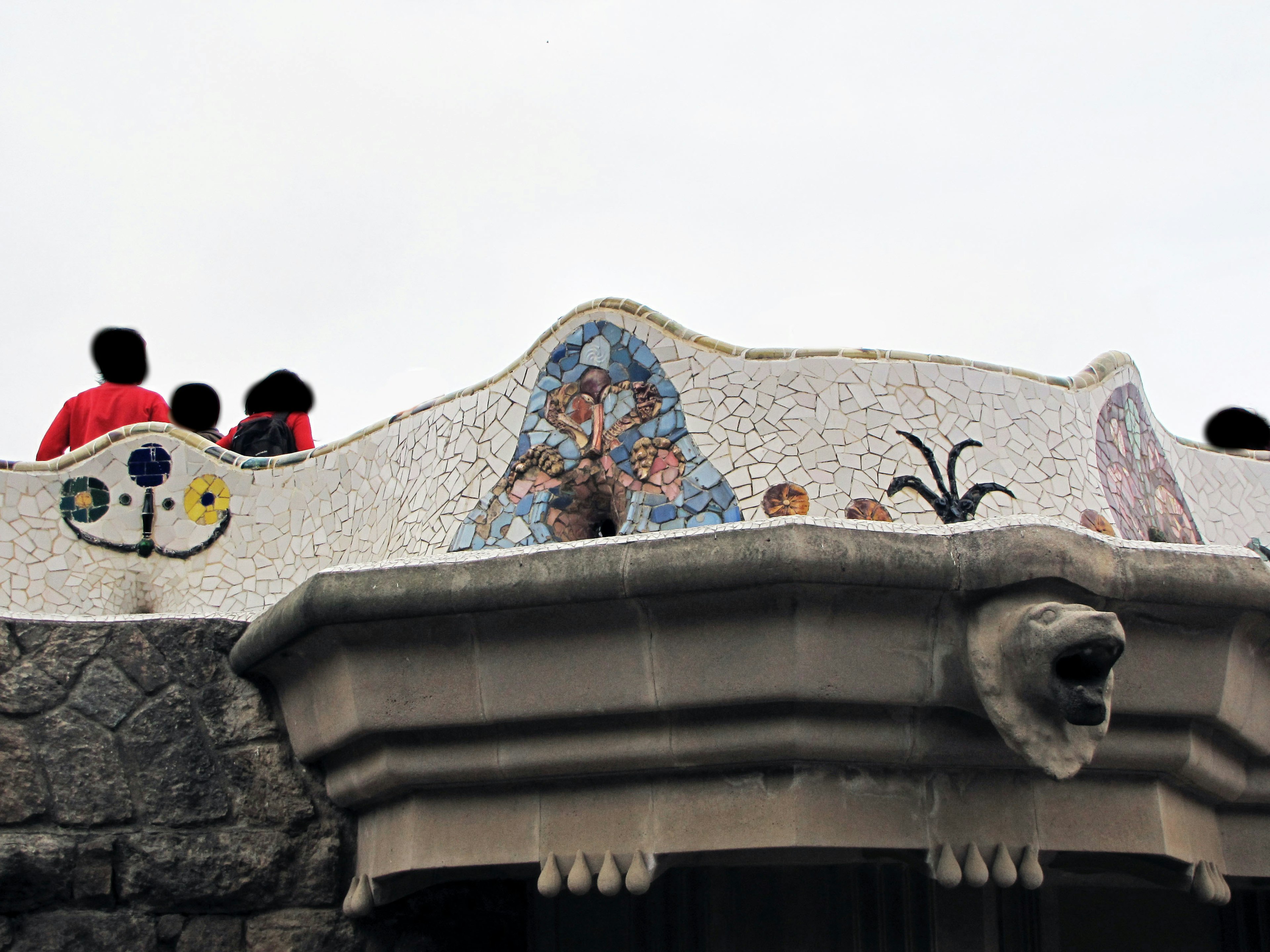 Visitors on the rooftop of Gaudi's Casa Batlló with mosaic decorations