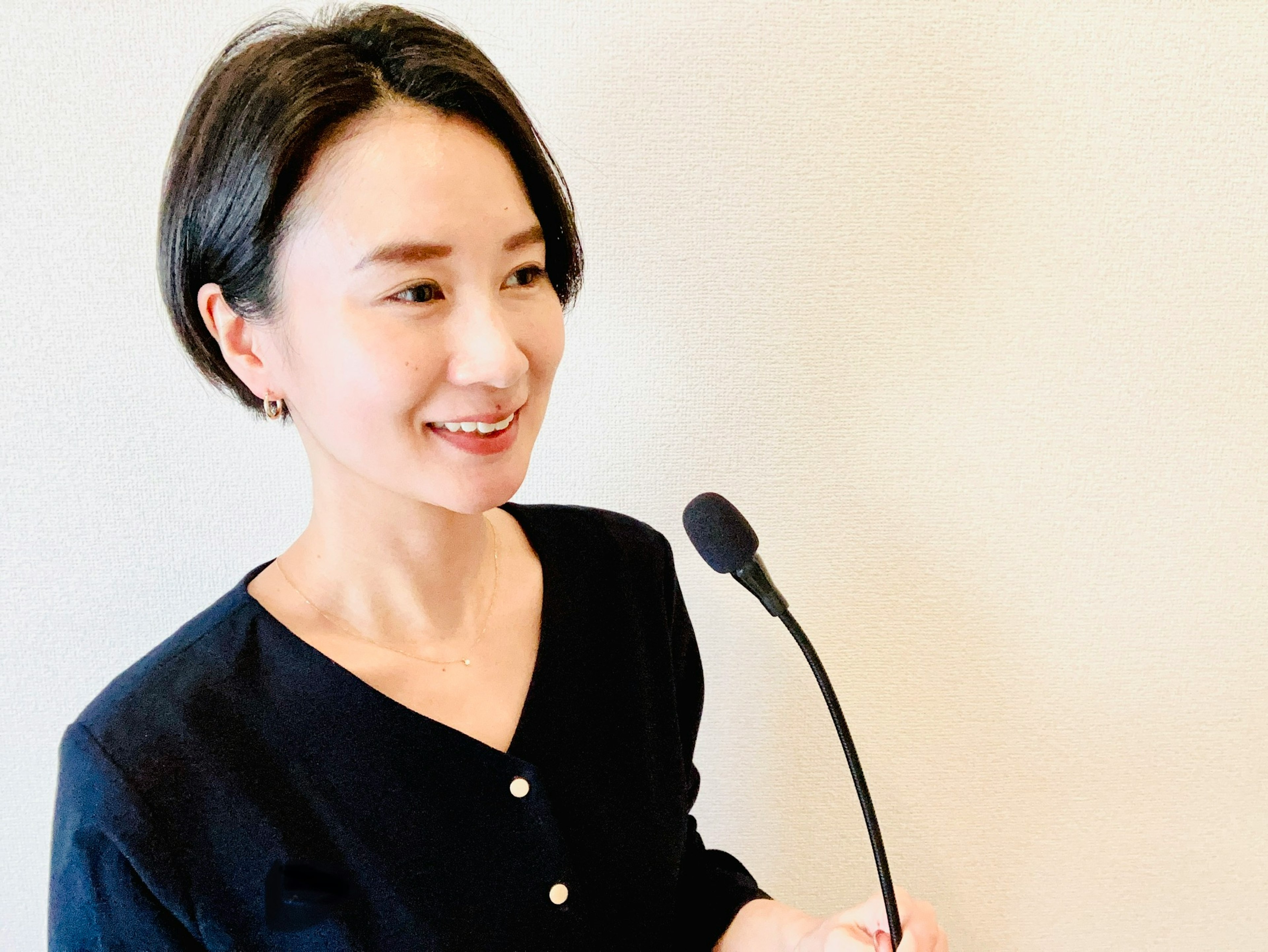 Portrait of a smiling woman holding a microphone