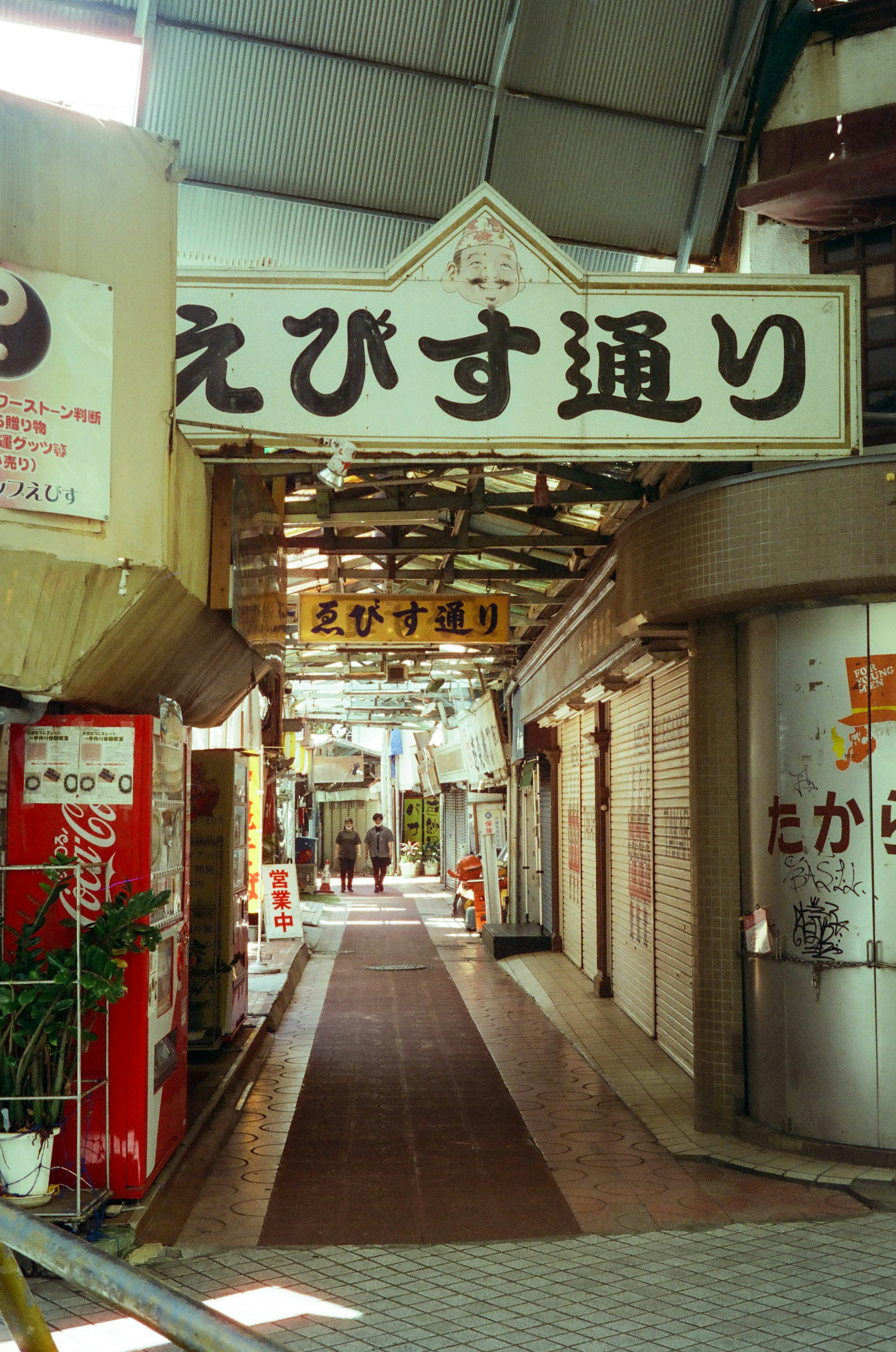 Vista dell'arcade di via Ebisu con negozi e insegne