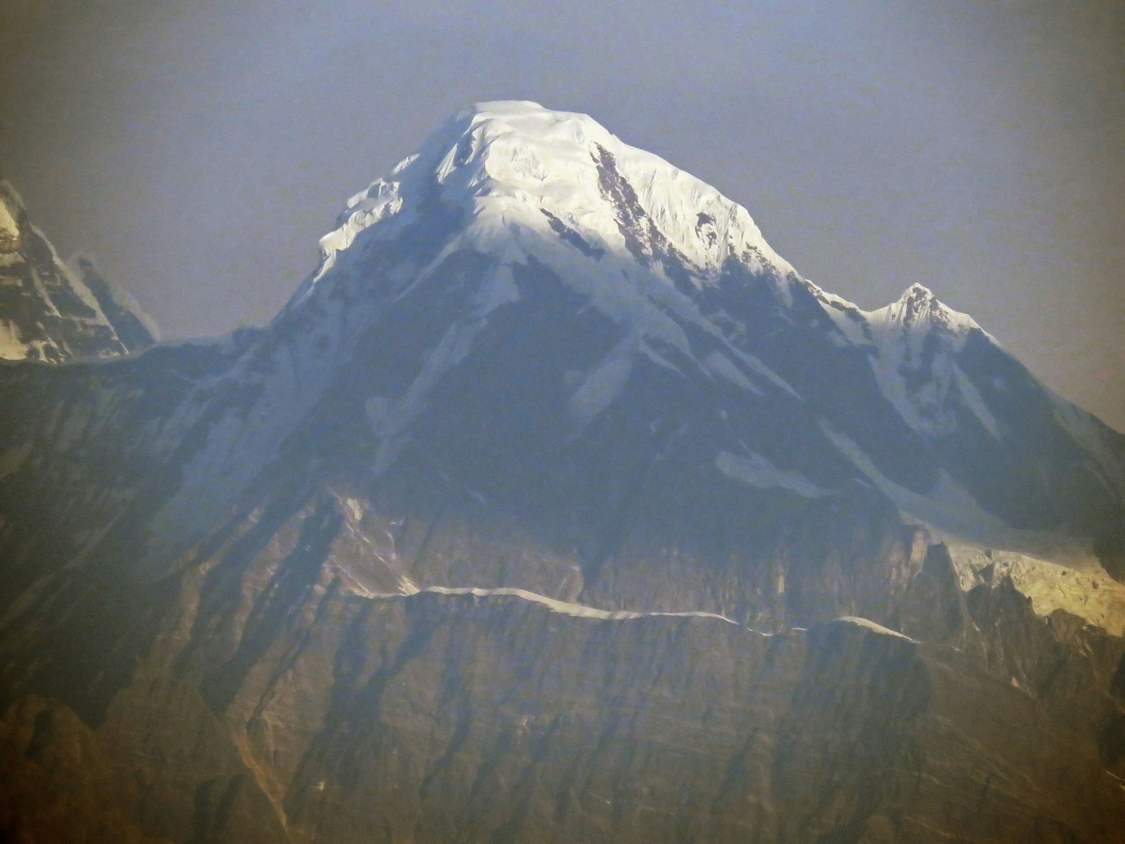 Snow-capped mountain peak with rugged terrain