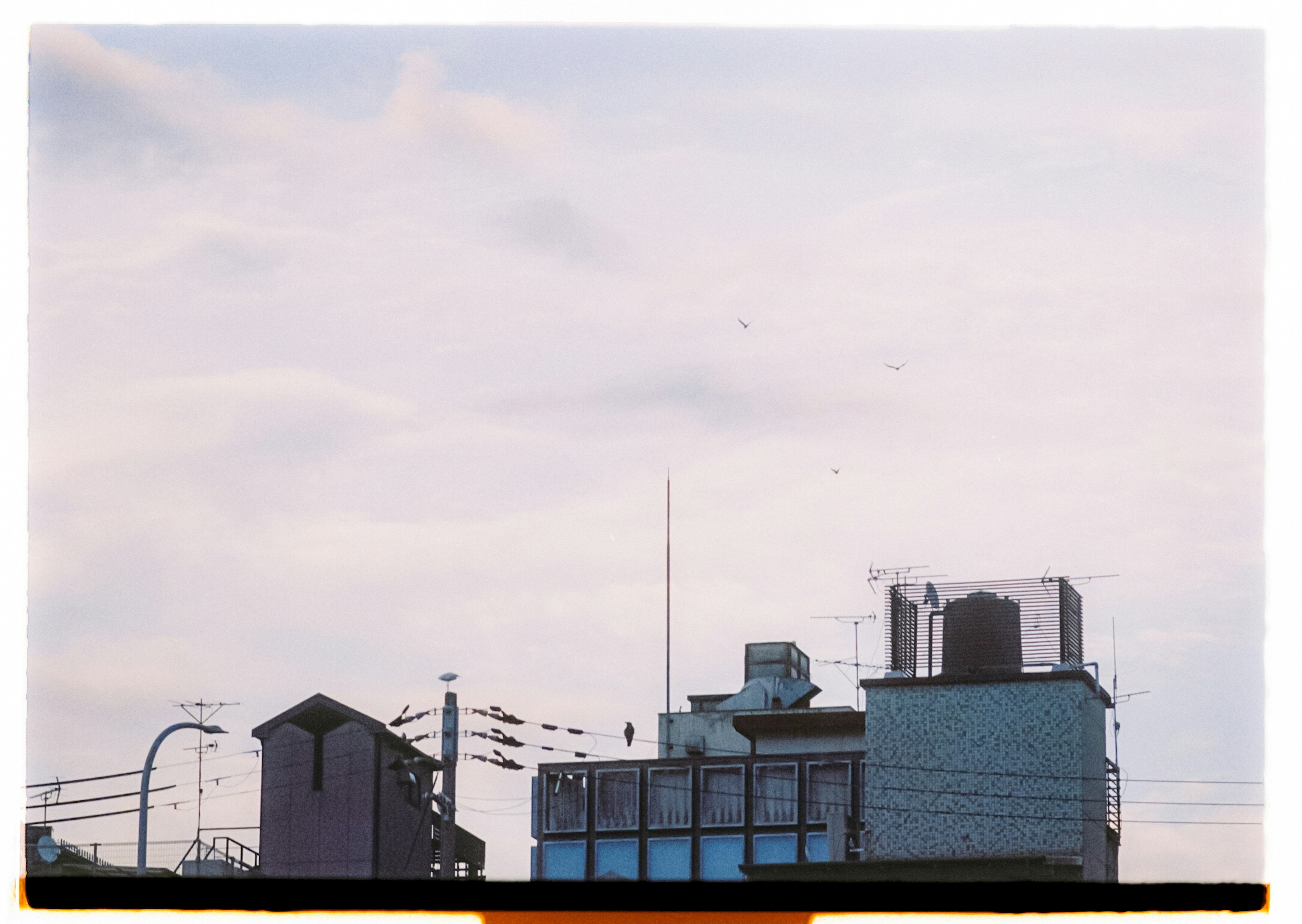 City skyline with rooftops antennas and power lines