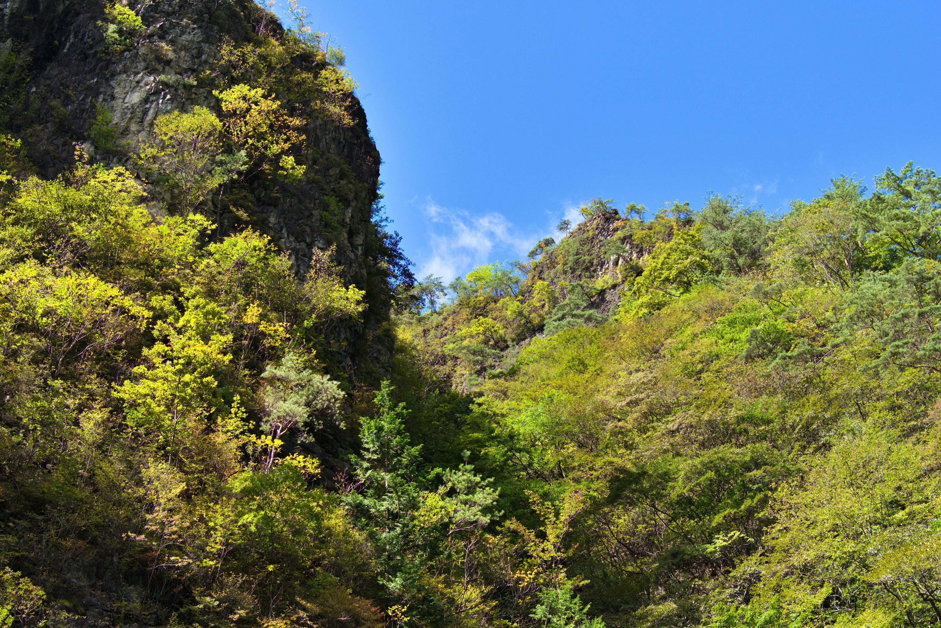 Landscape of green mountains under a blue sky