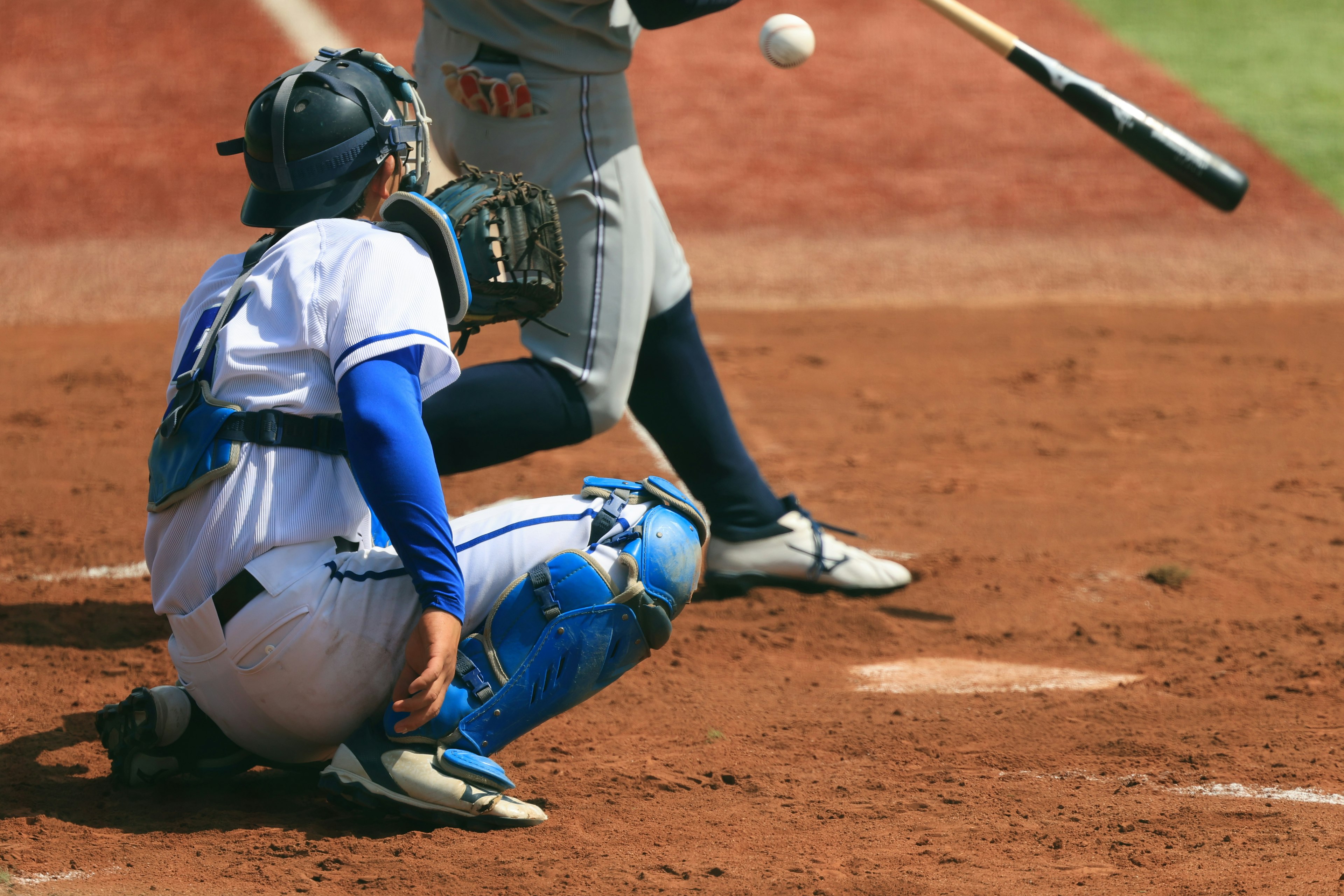 A catcher receiving a pitch during a baseball game