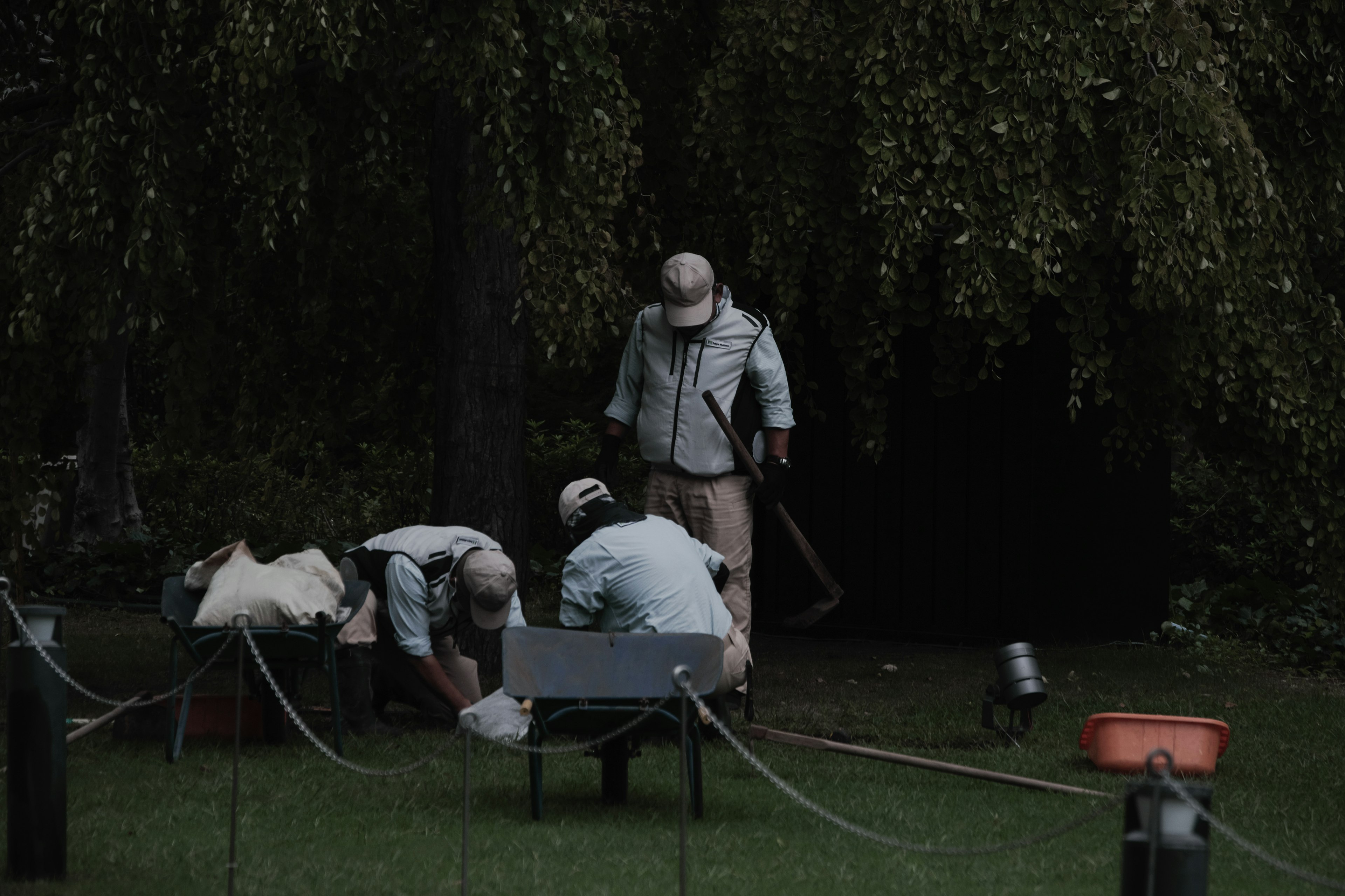 People in work clothes maintaining a park