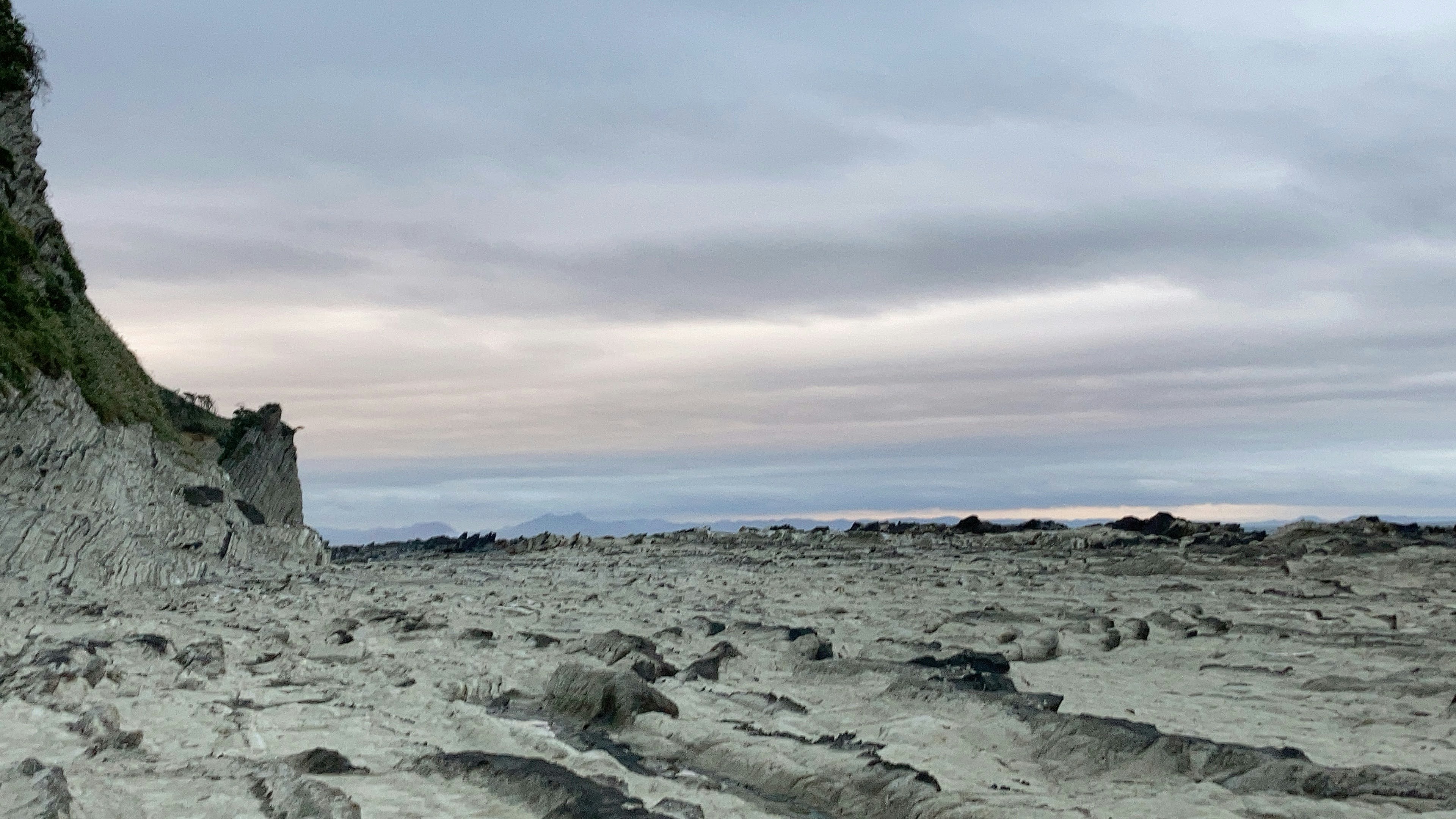 Coastal rocky shoreline with overcast sky