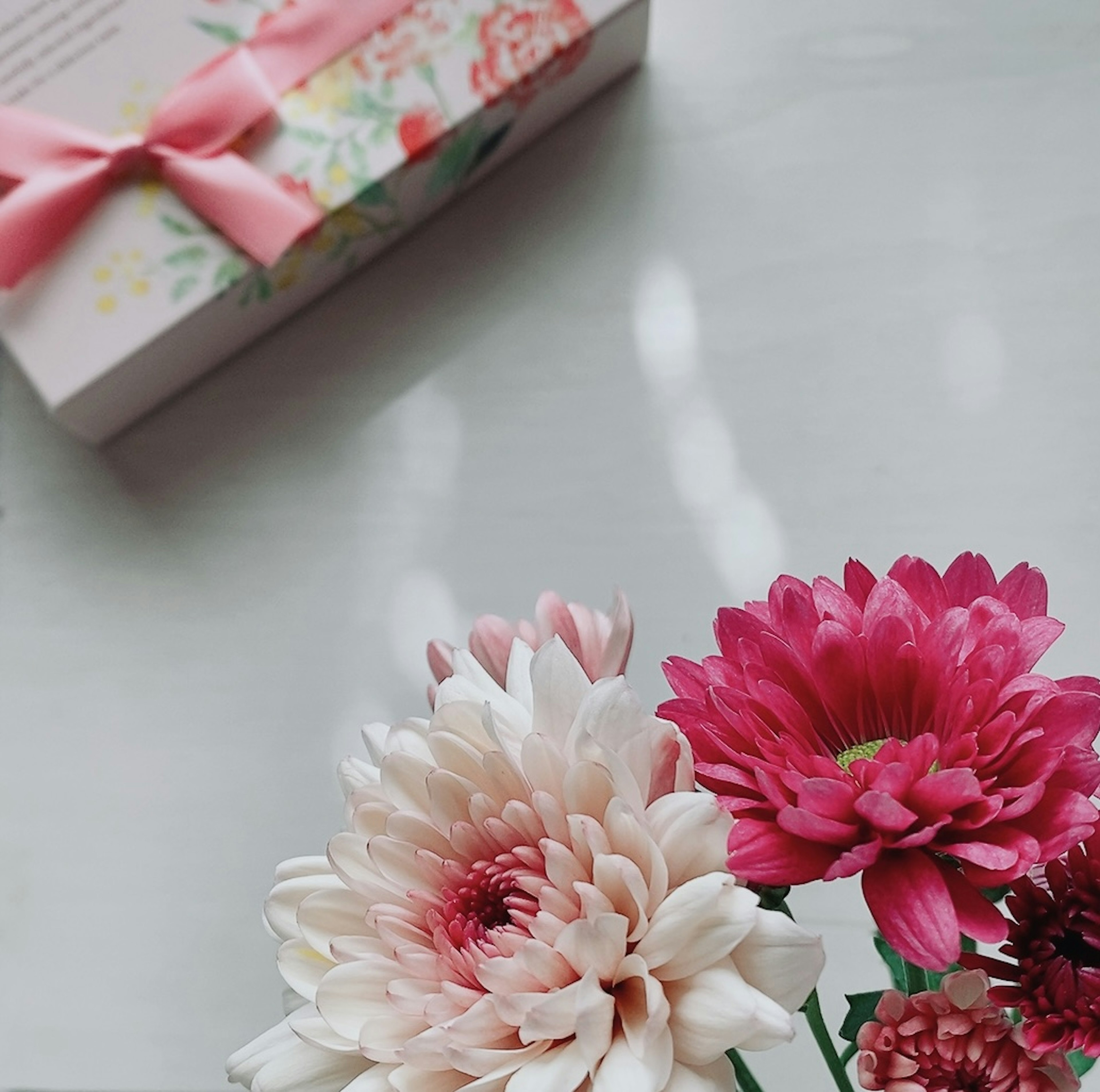 Beautiful arrangement of flowers with a gift box