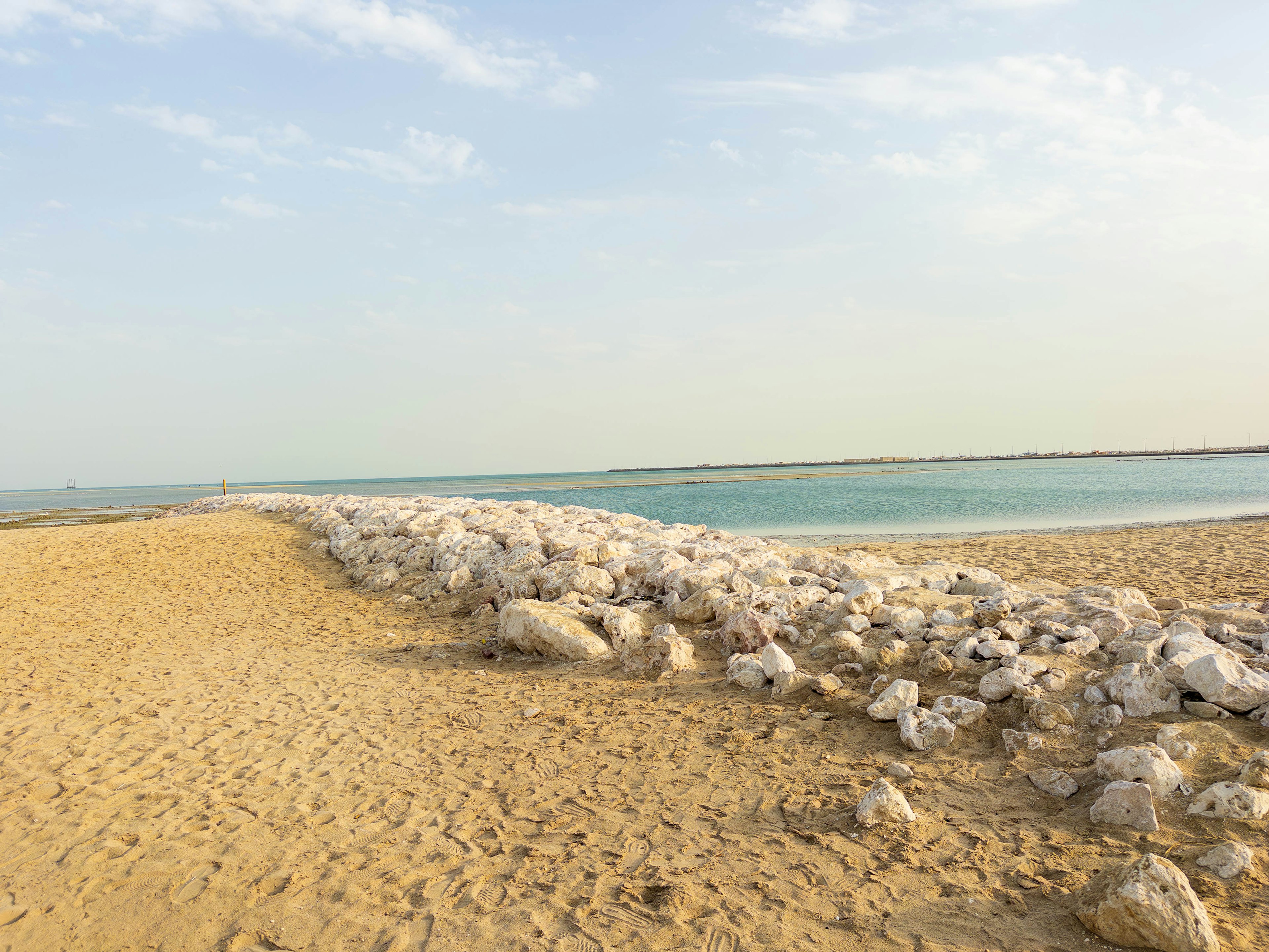 Beach scene featuring white rocks along the shoreline