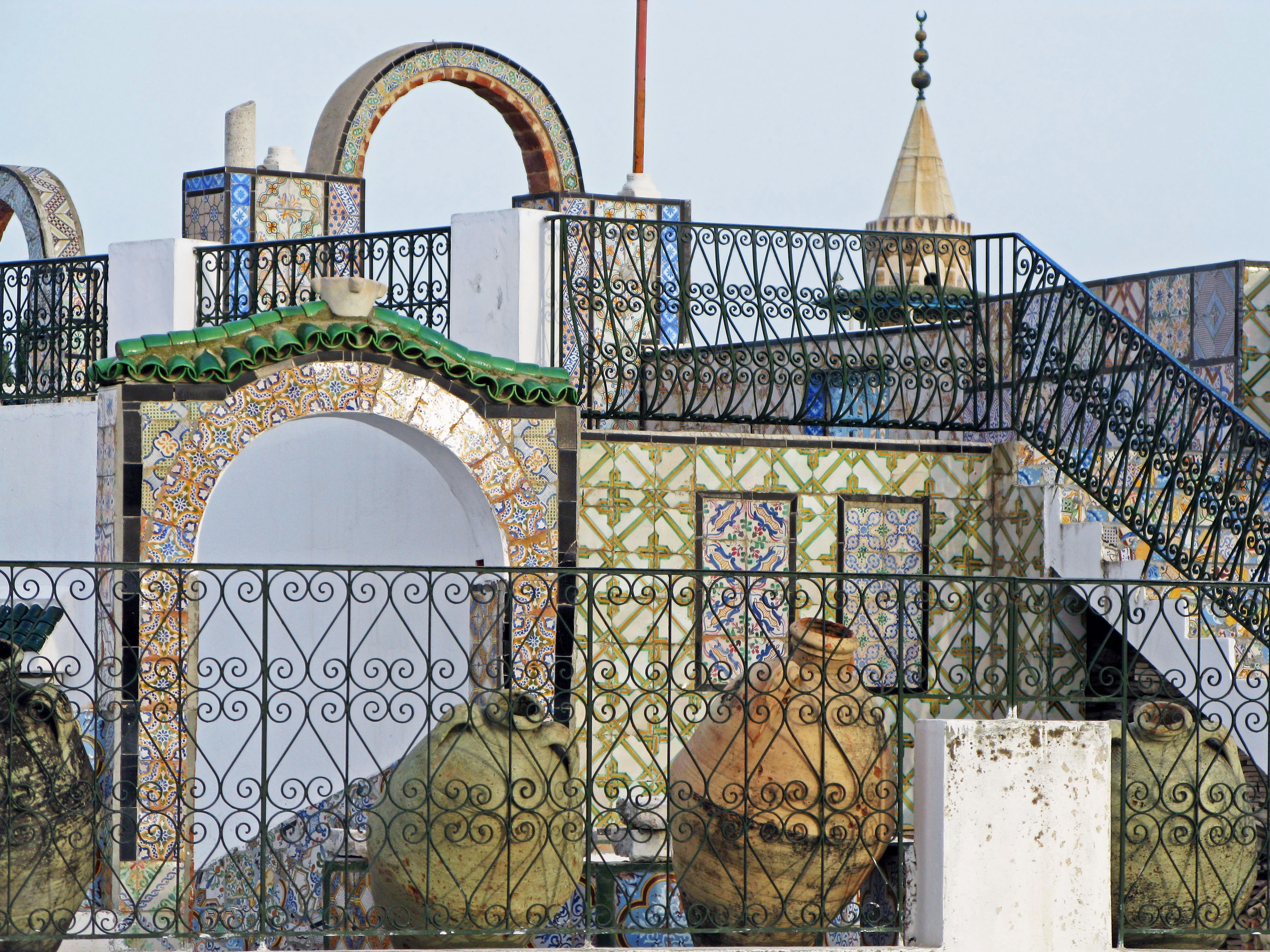 Colorful tiled building with large pots in the foreground