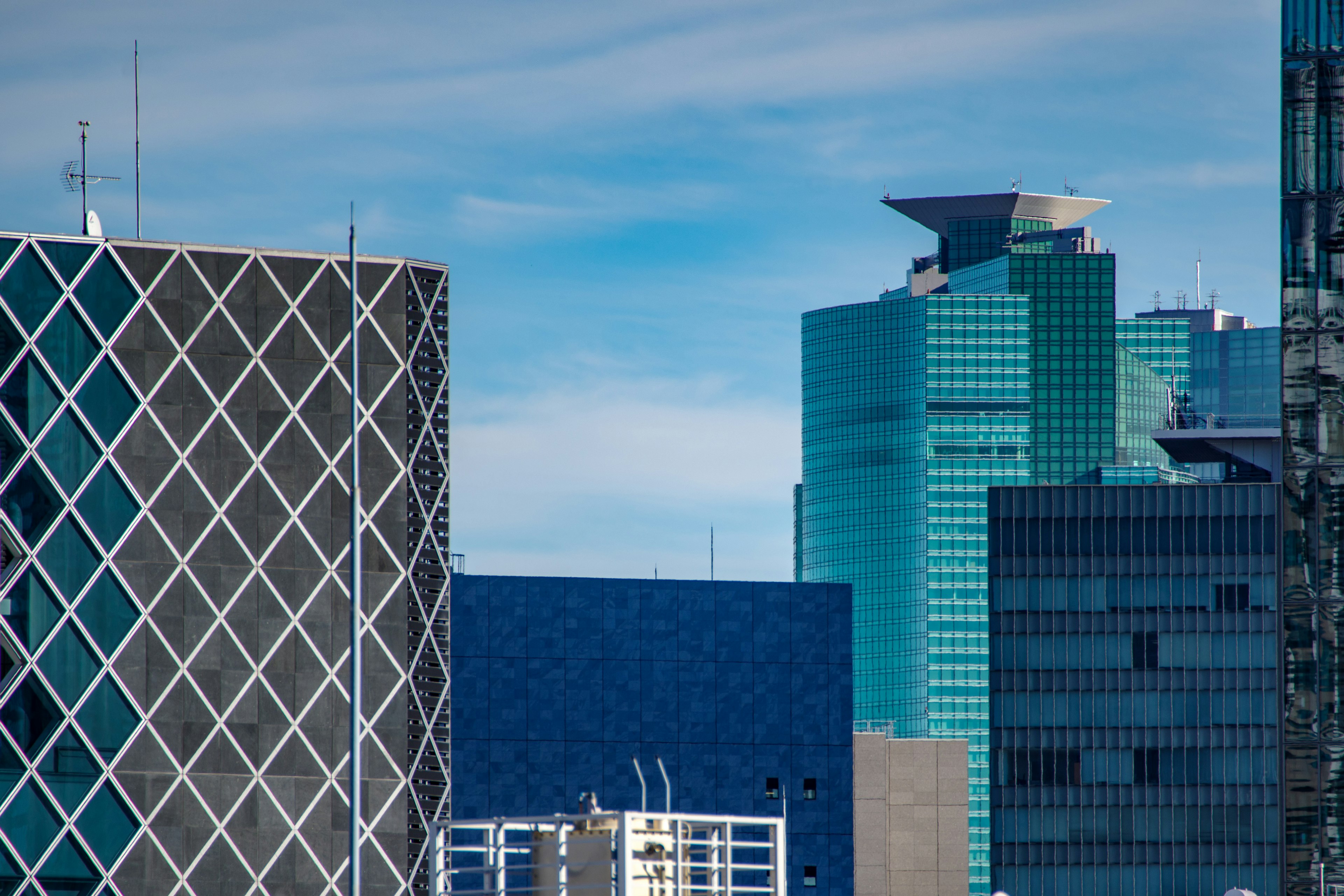 Close-up of modern skyscrapers with a blue sky and contrasting buildings