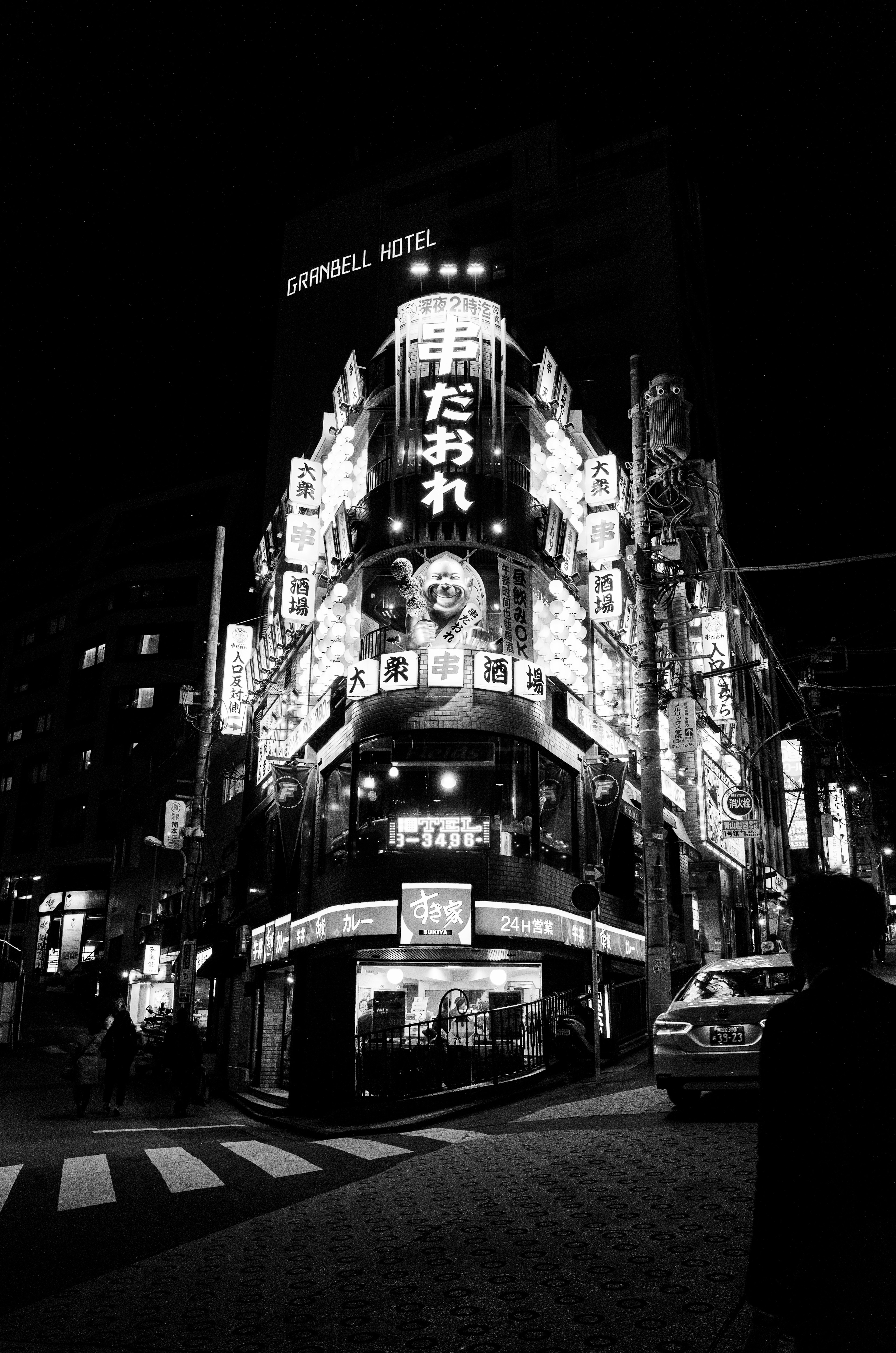 Neon signs illuminating a street corner at night