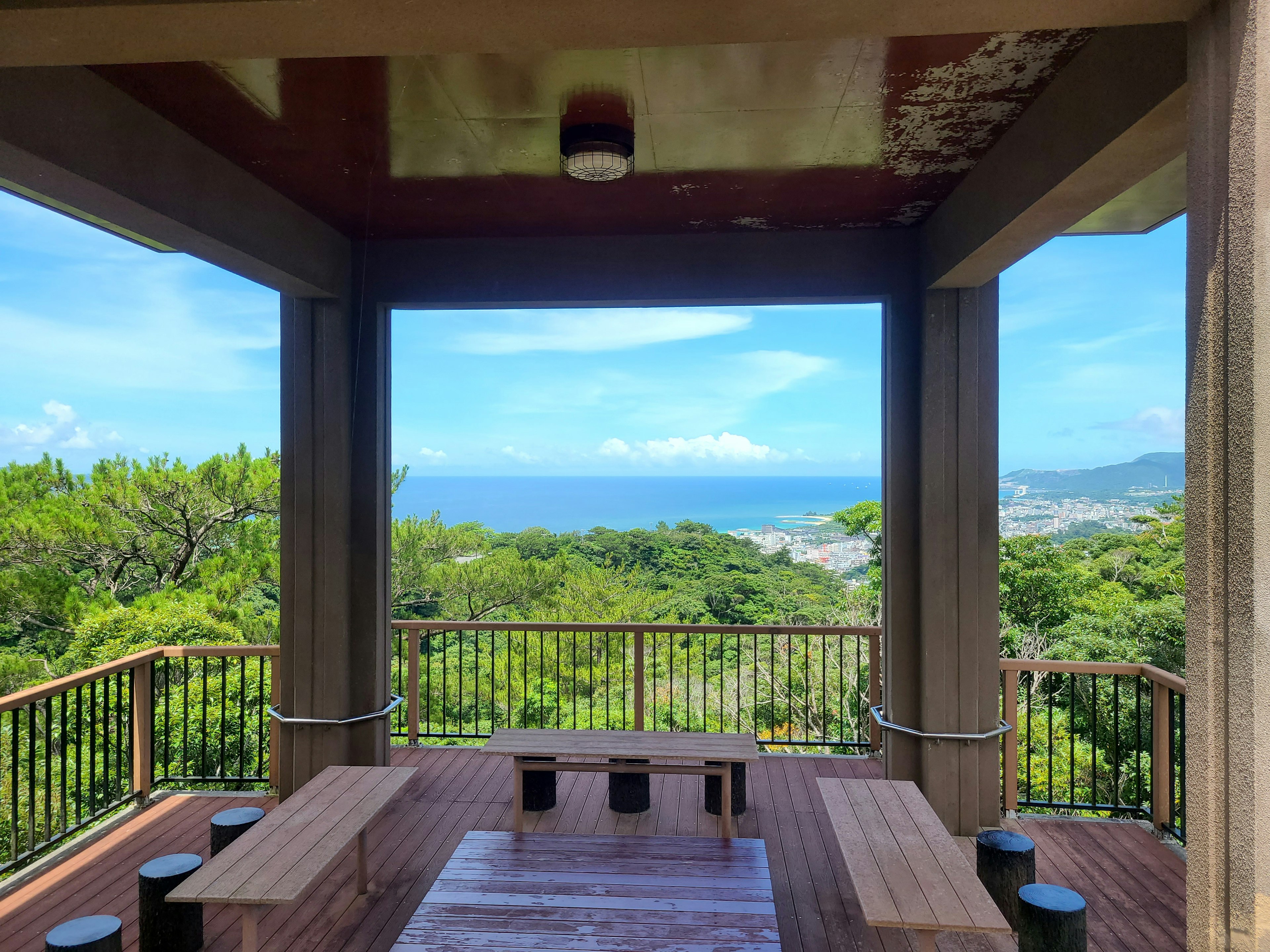 Outdoor resting area overlooking the sea and greenery