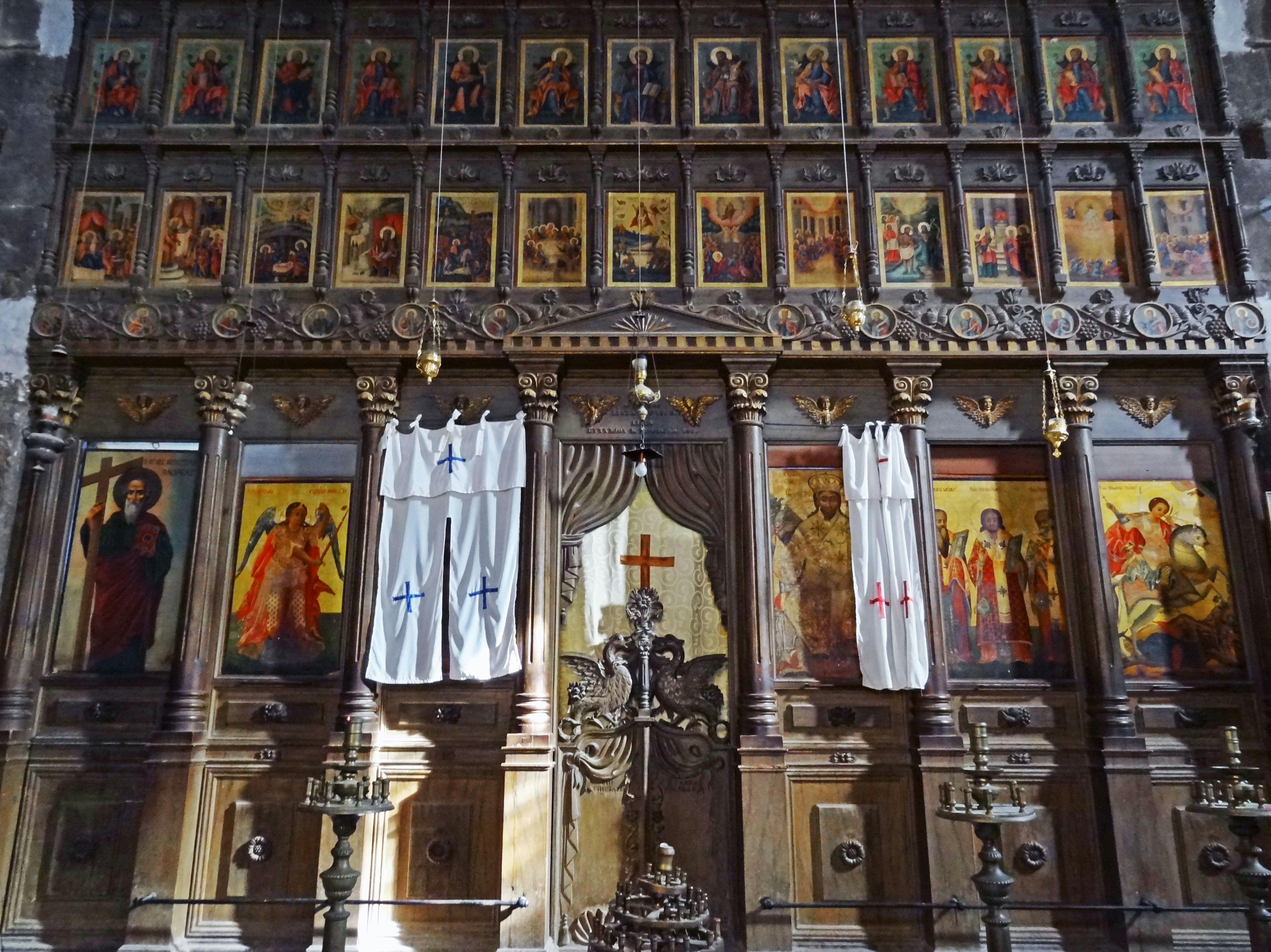 Interior of a church featuring beautiful icons displayed on a wooden altar