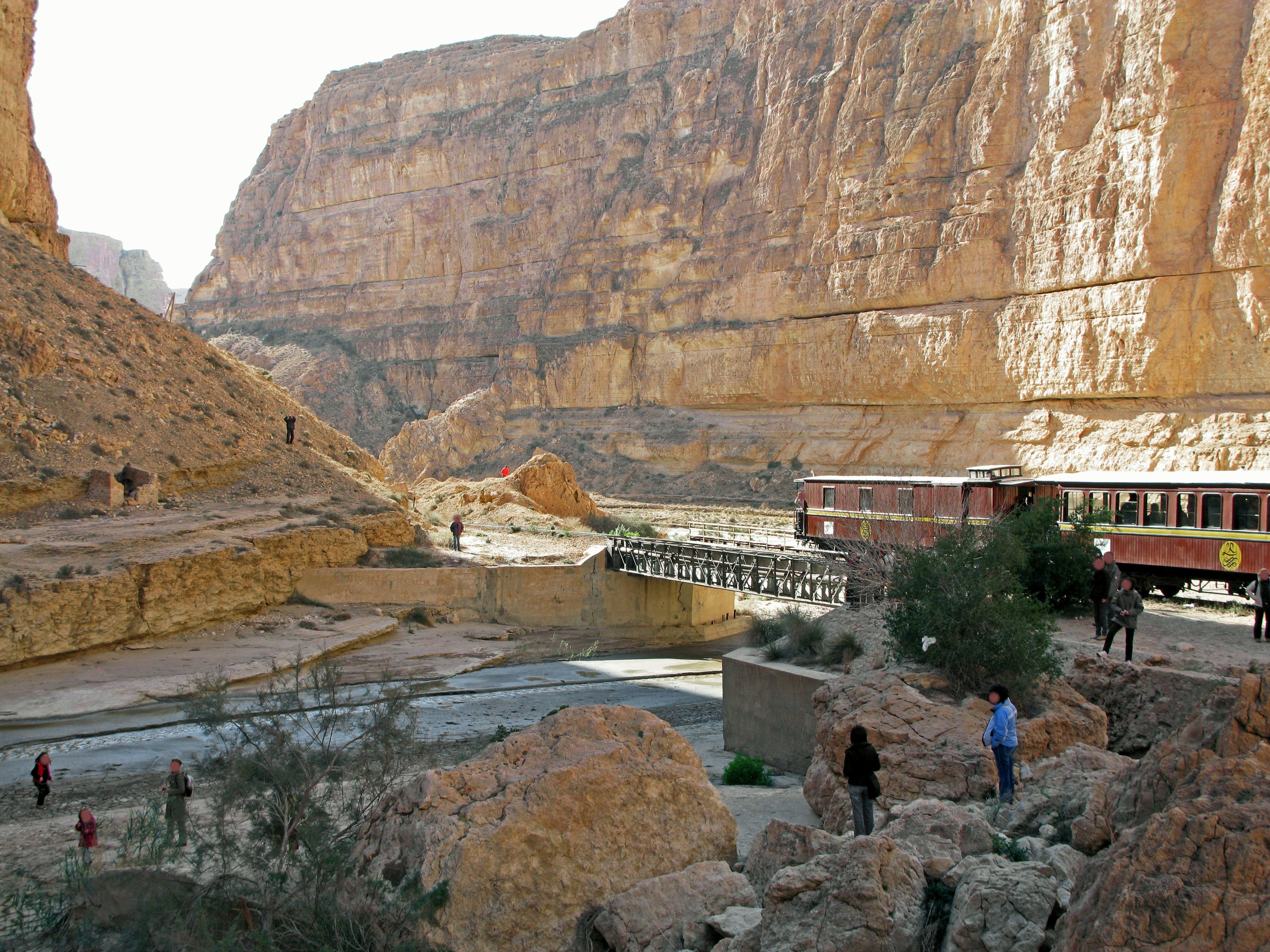 Scenic view of a canyon with towering rock formations and people exploring