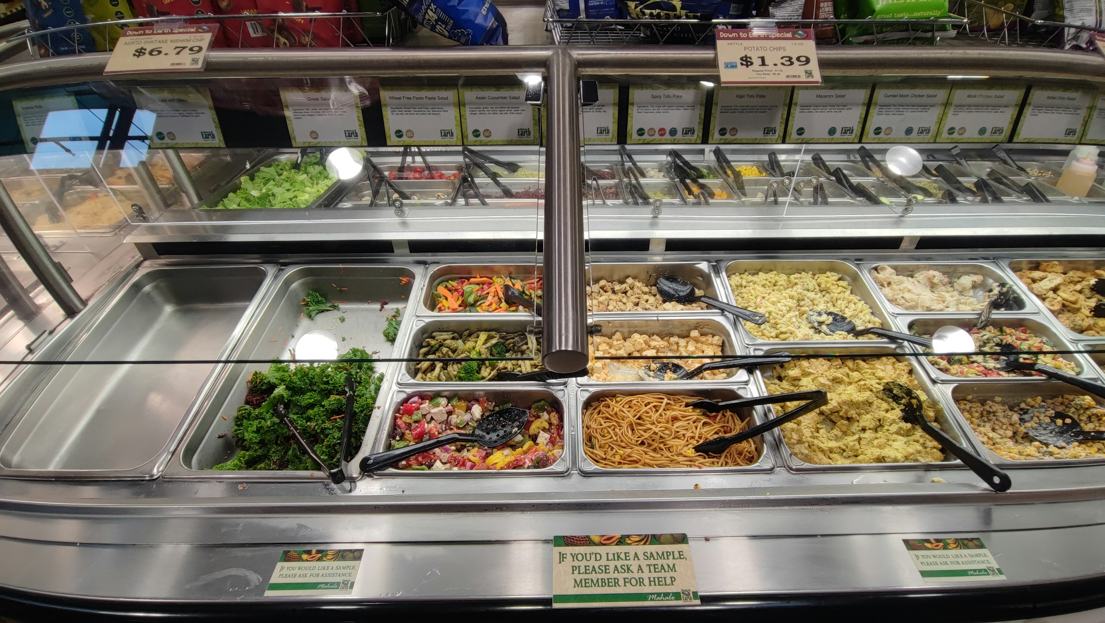 Salad bar featuring a variety of dishes in containers