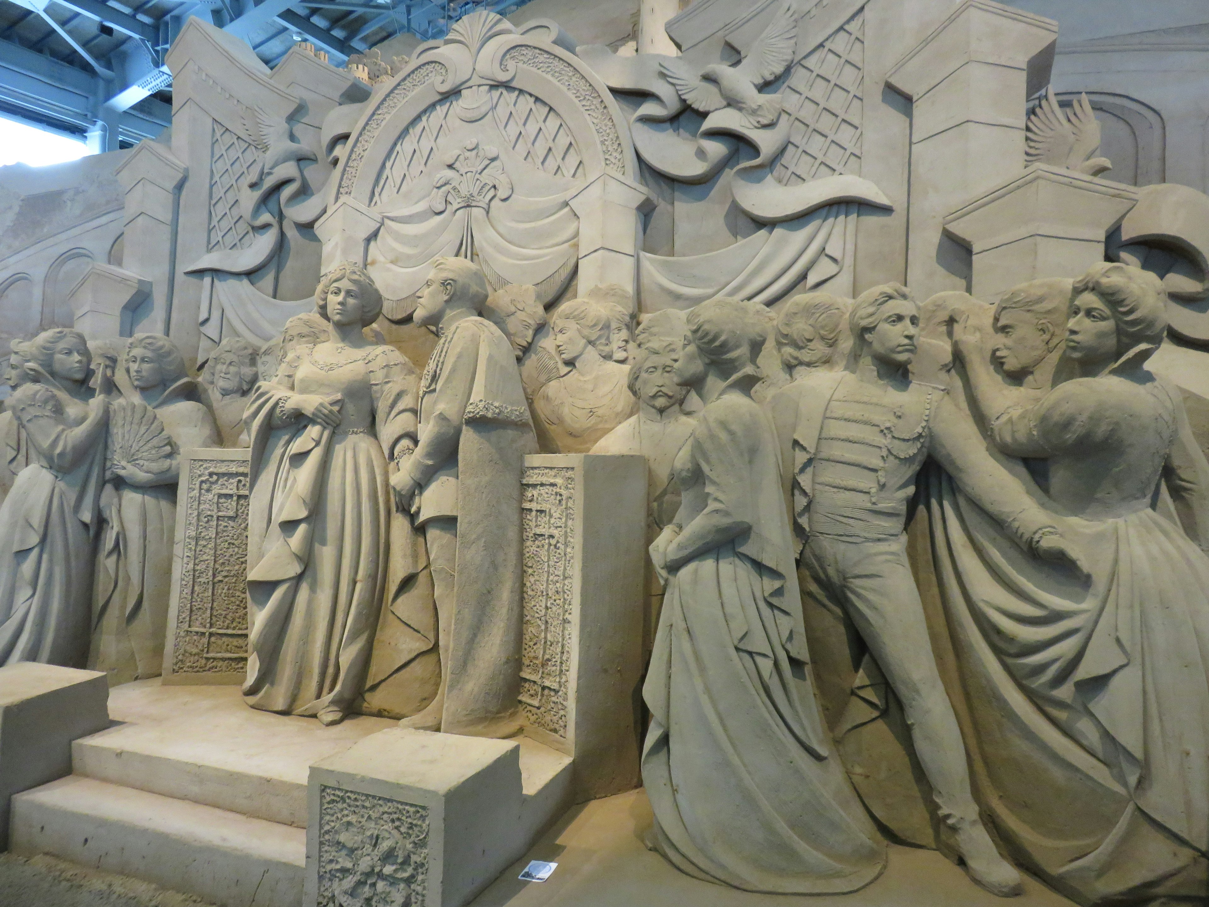 A stunning sand sculpture featuring a group of intricately carved figures