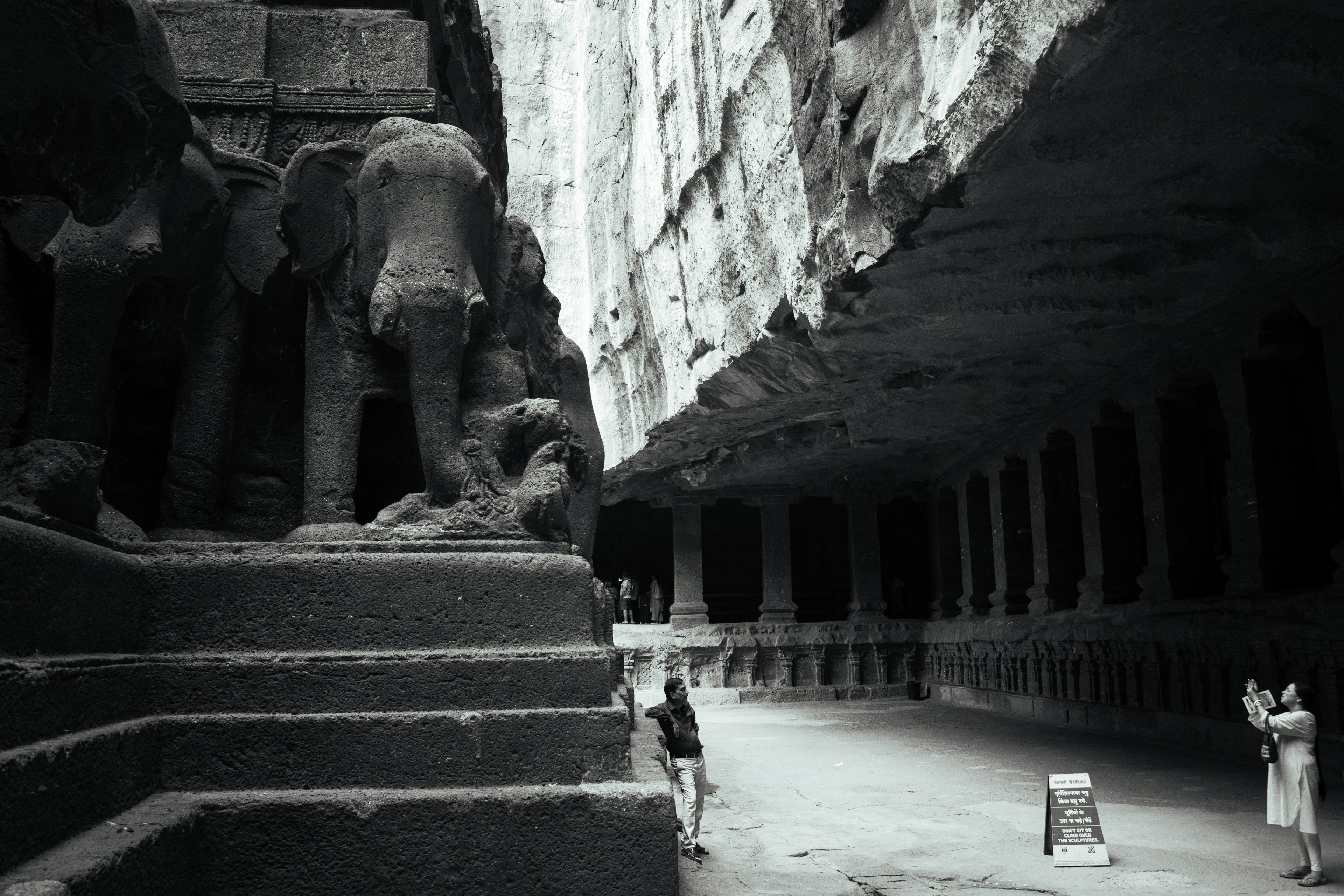 Elephanta Island cave temple with sculptures and visitors