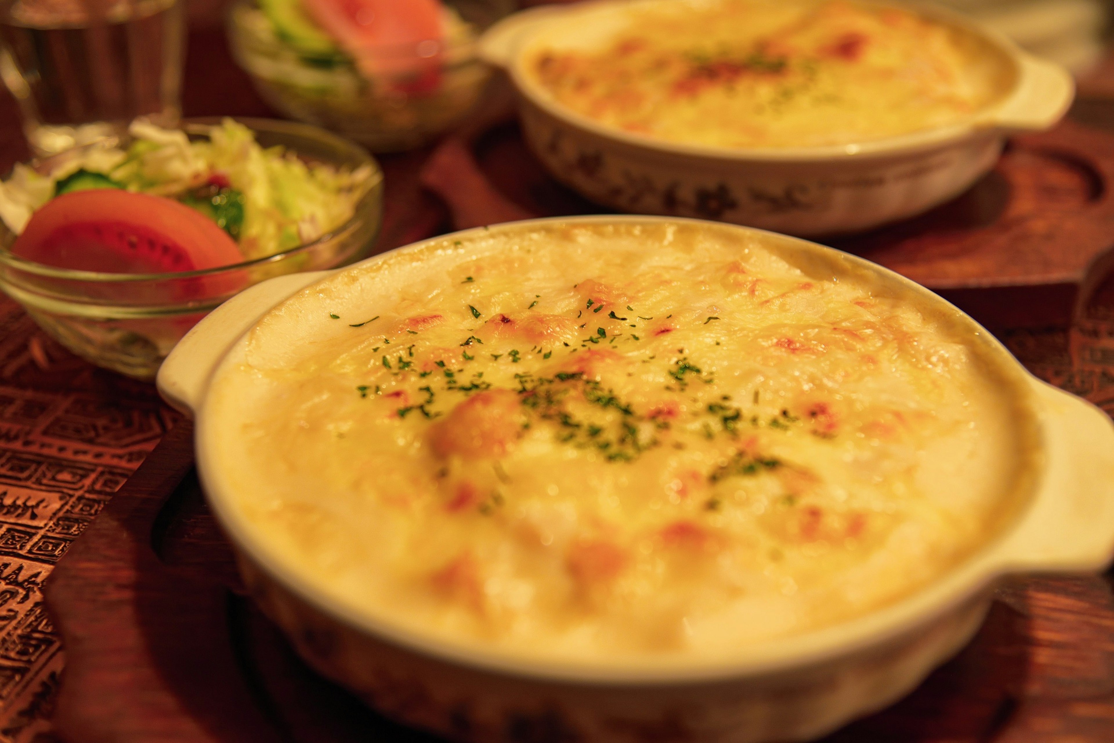 Creamy cheese gratin served in a dish with a side salad