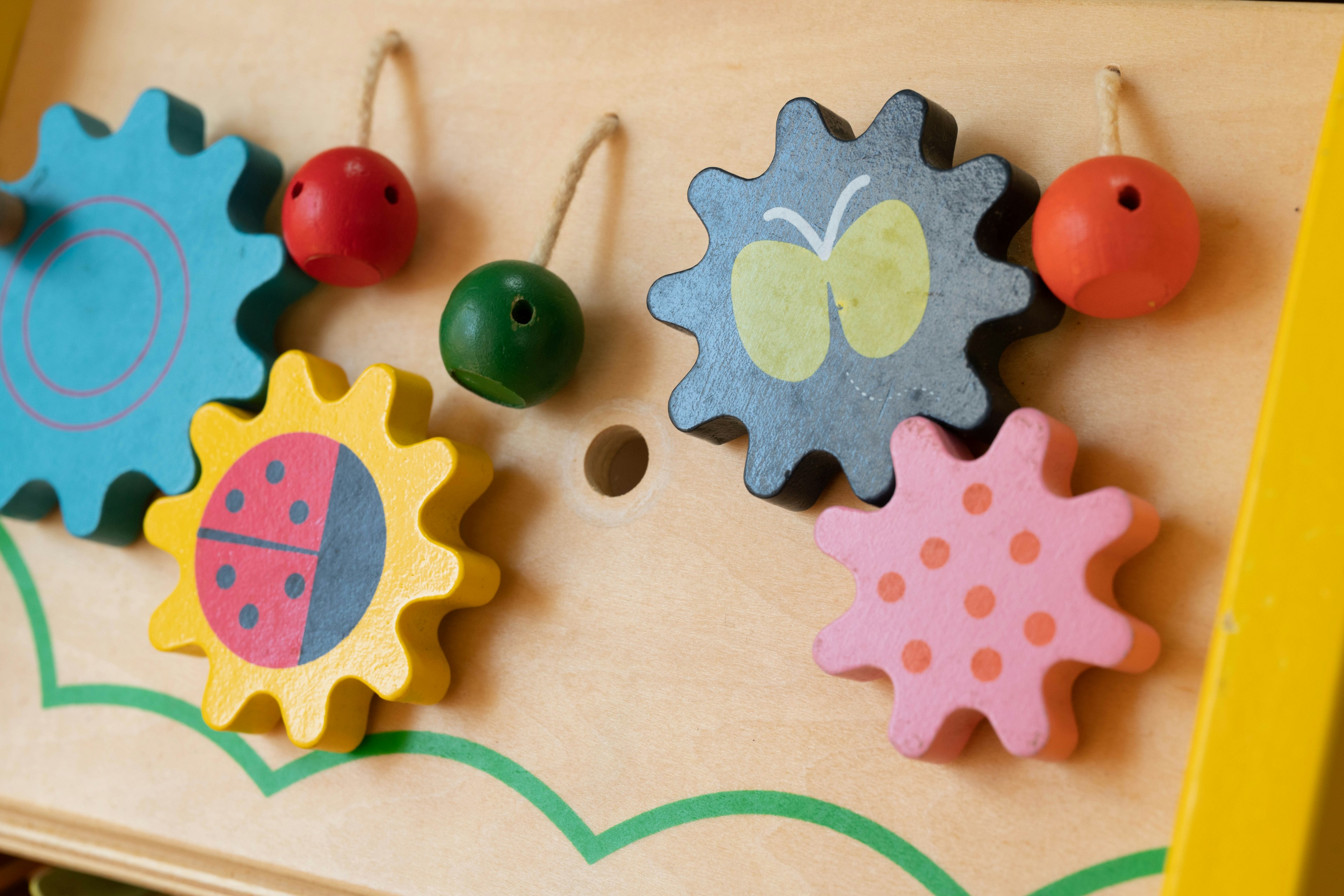 Colorful wooden gears and beads designed for a children's toy