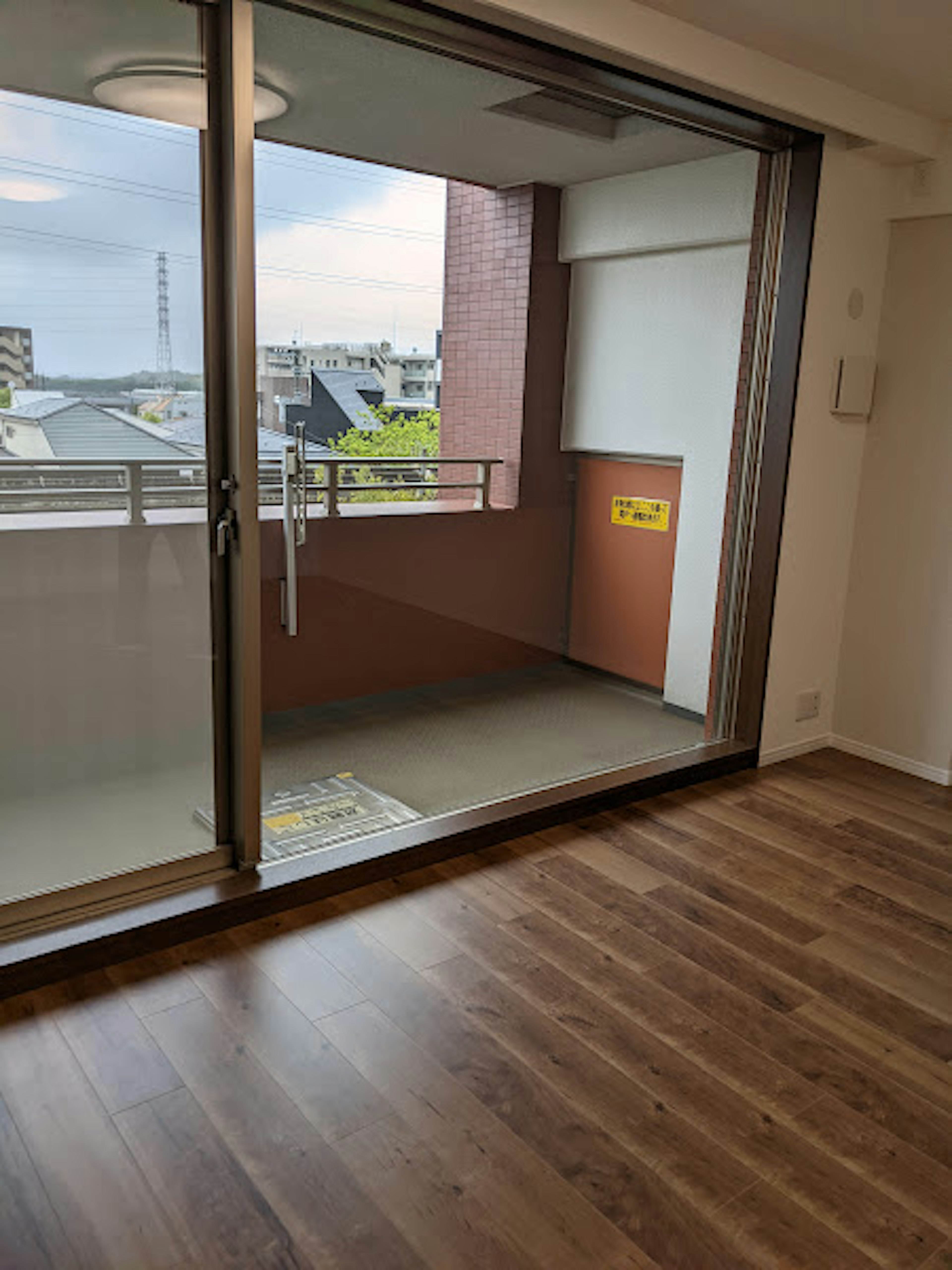 Bright living room with a view of the balcony through large windows