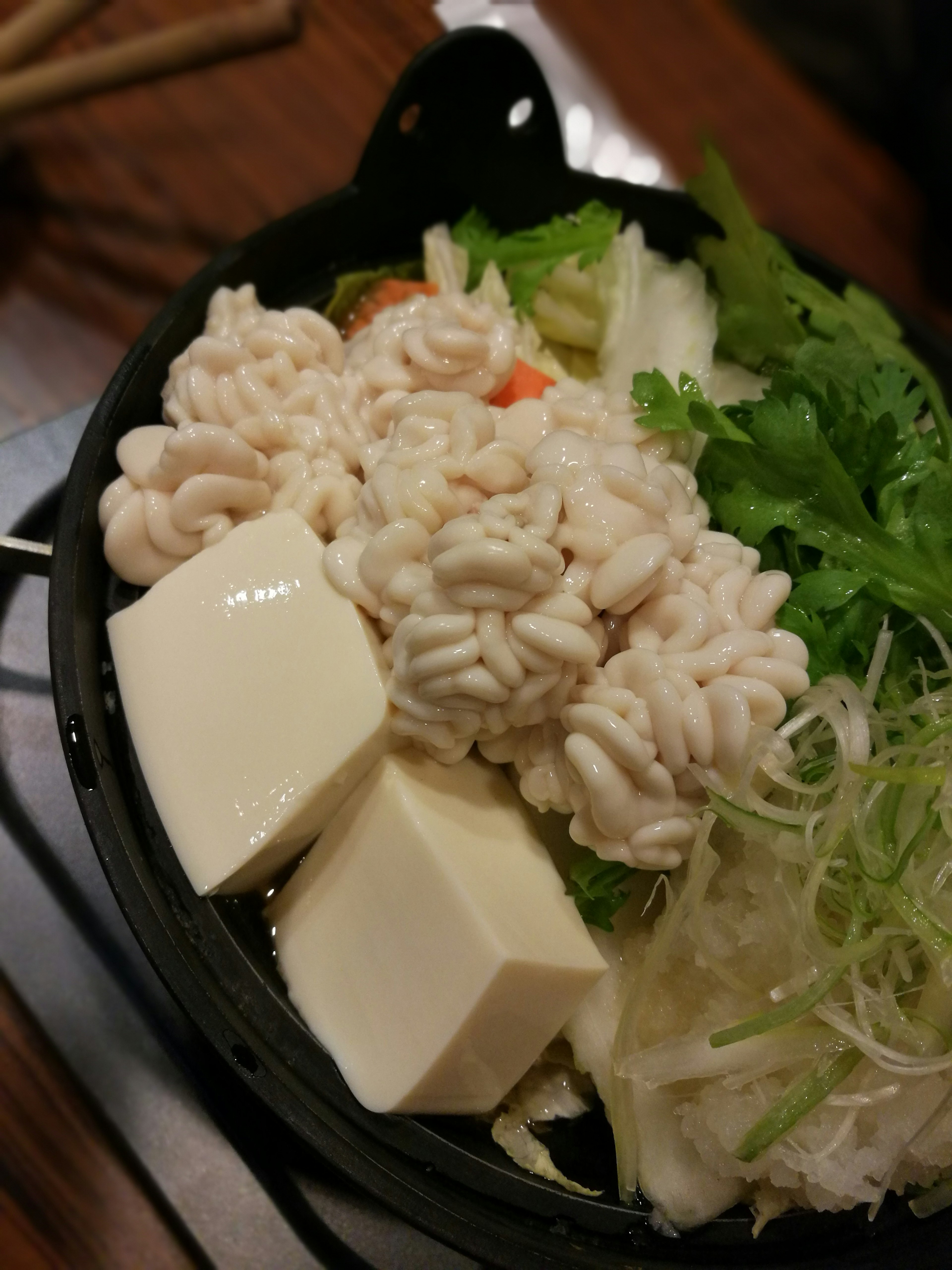 A bowl of tofu and vegetables with noodles