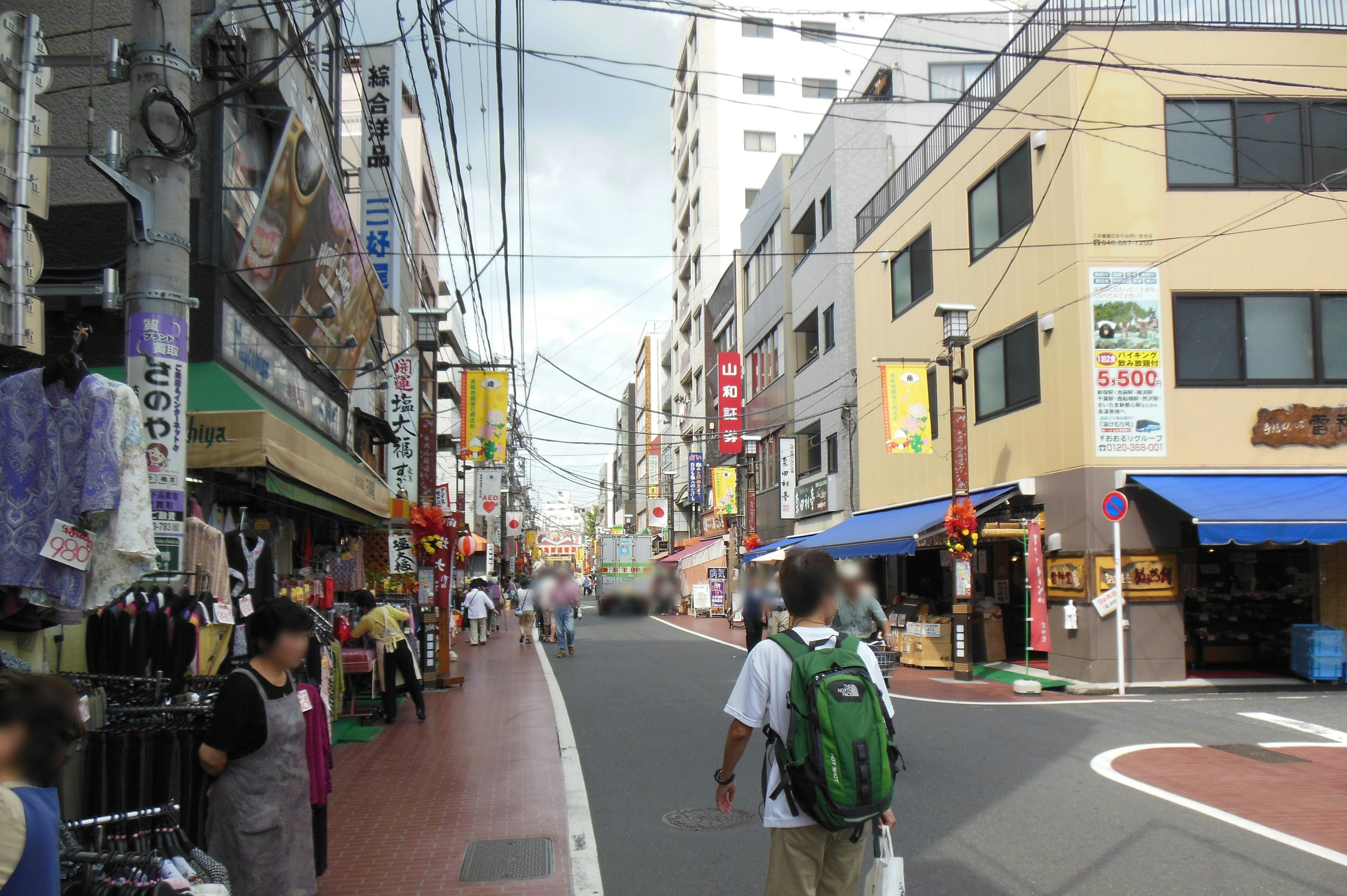 Busy street scene in a Japanese shopping district with people walking