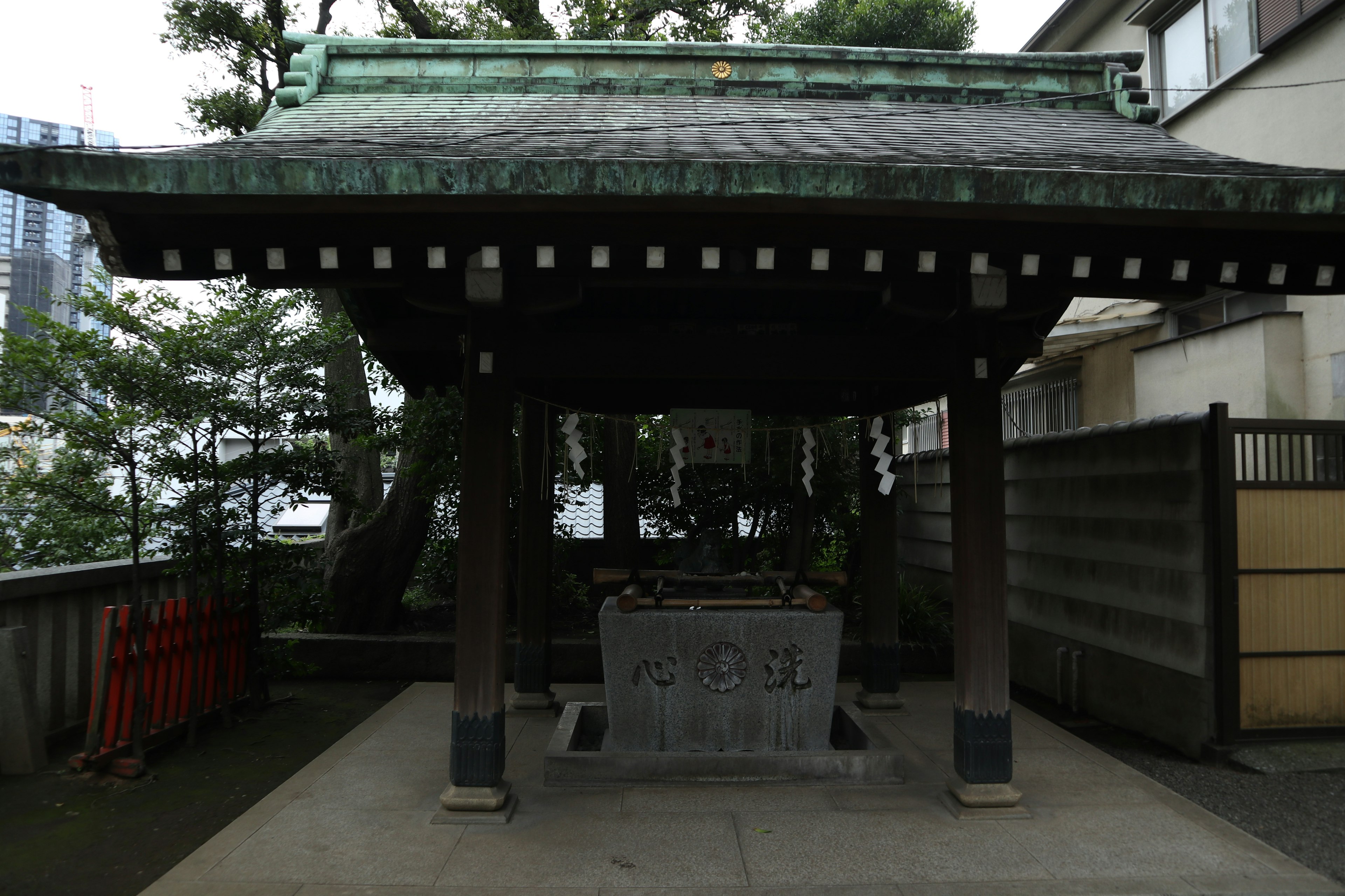 Traditional Japanese structure with a green roof in a serene setting