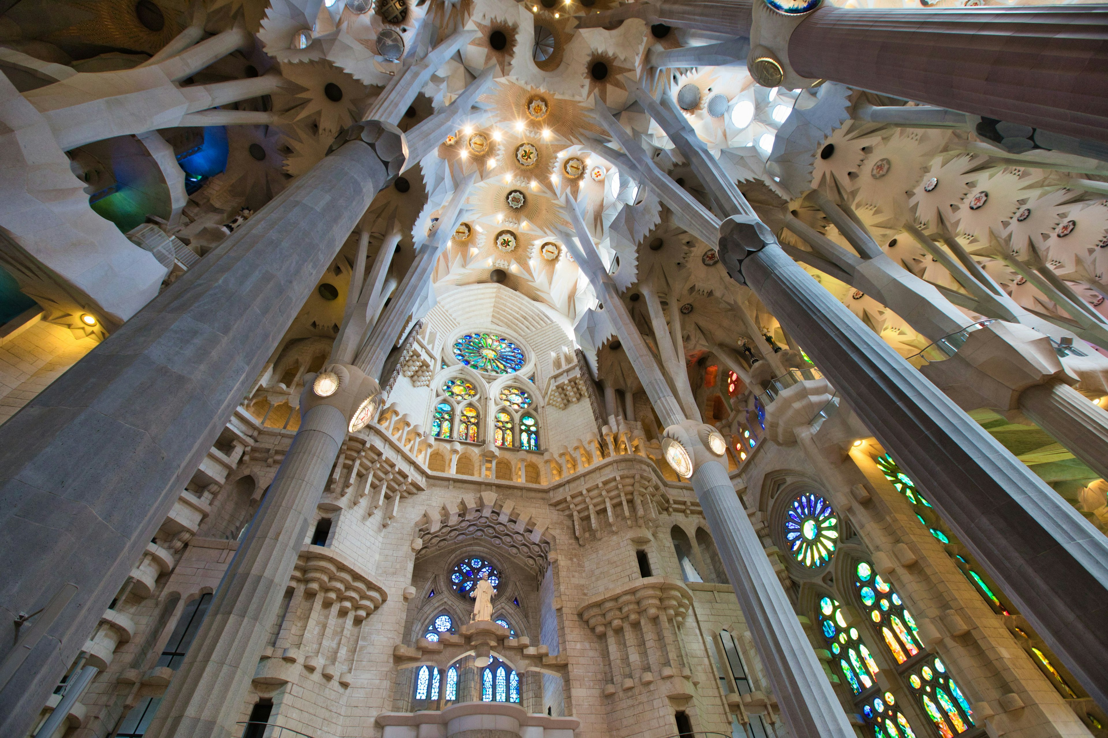 Interior view of Sagrada Familia showing beautiful stained glass and unique columns