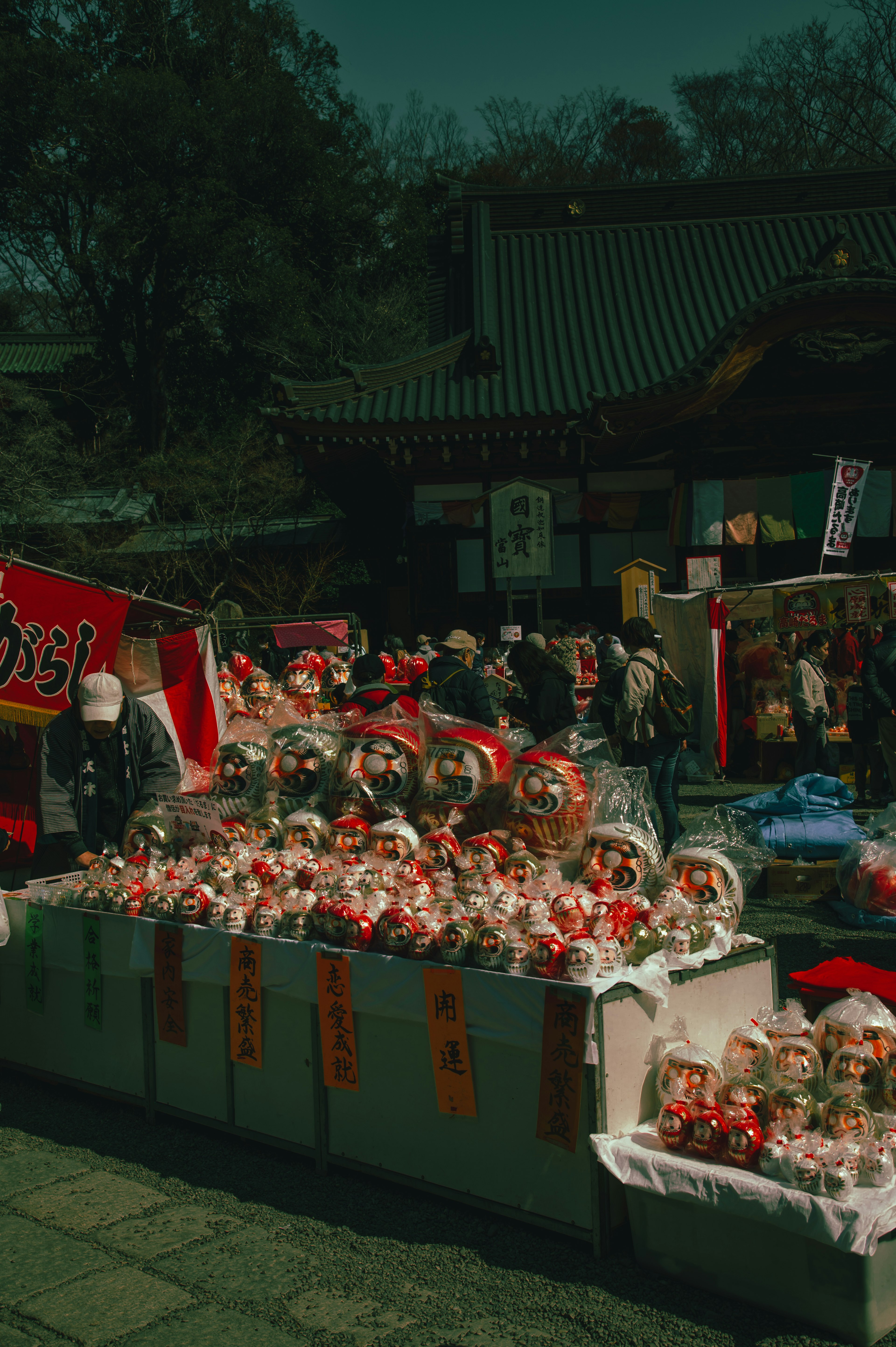 Vibrant market scene with rows of red charms and decorations