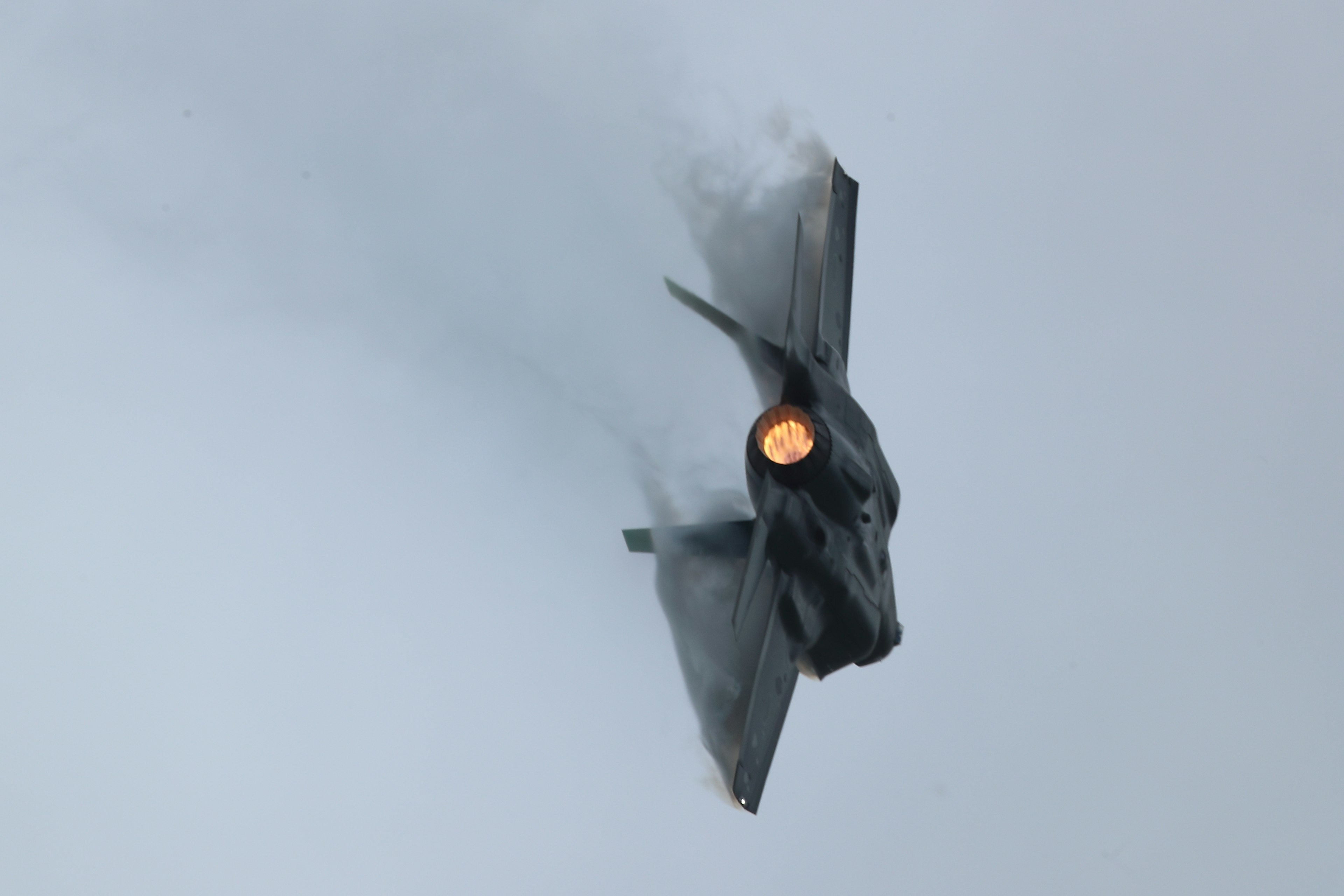 F-35 fighter jet performing a sharp turn in the sky